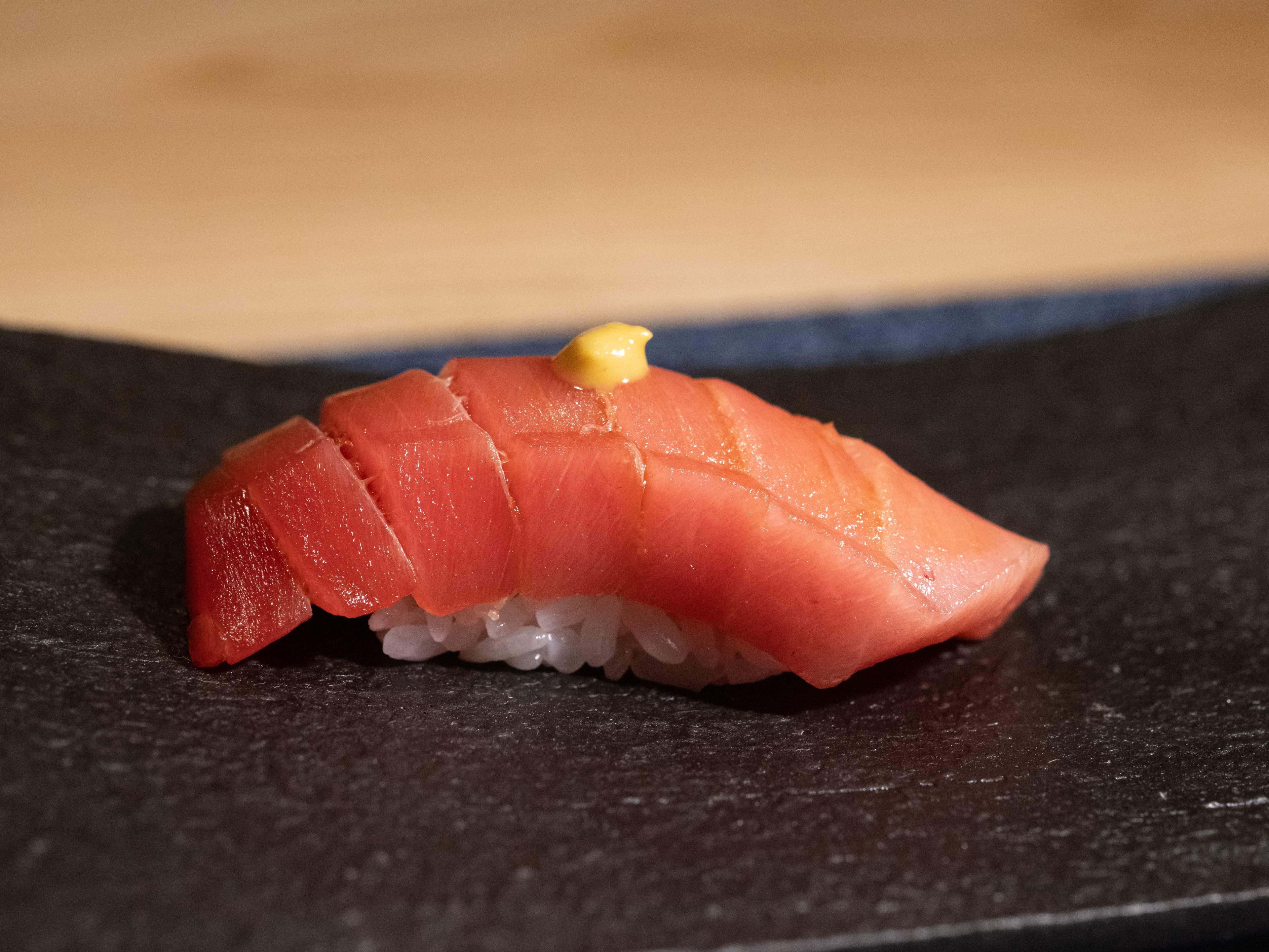 salmon nigiri with tiny dollop of sauce on top