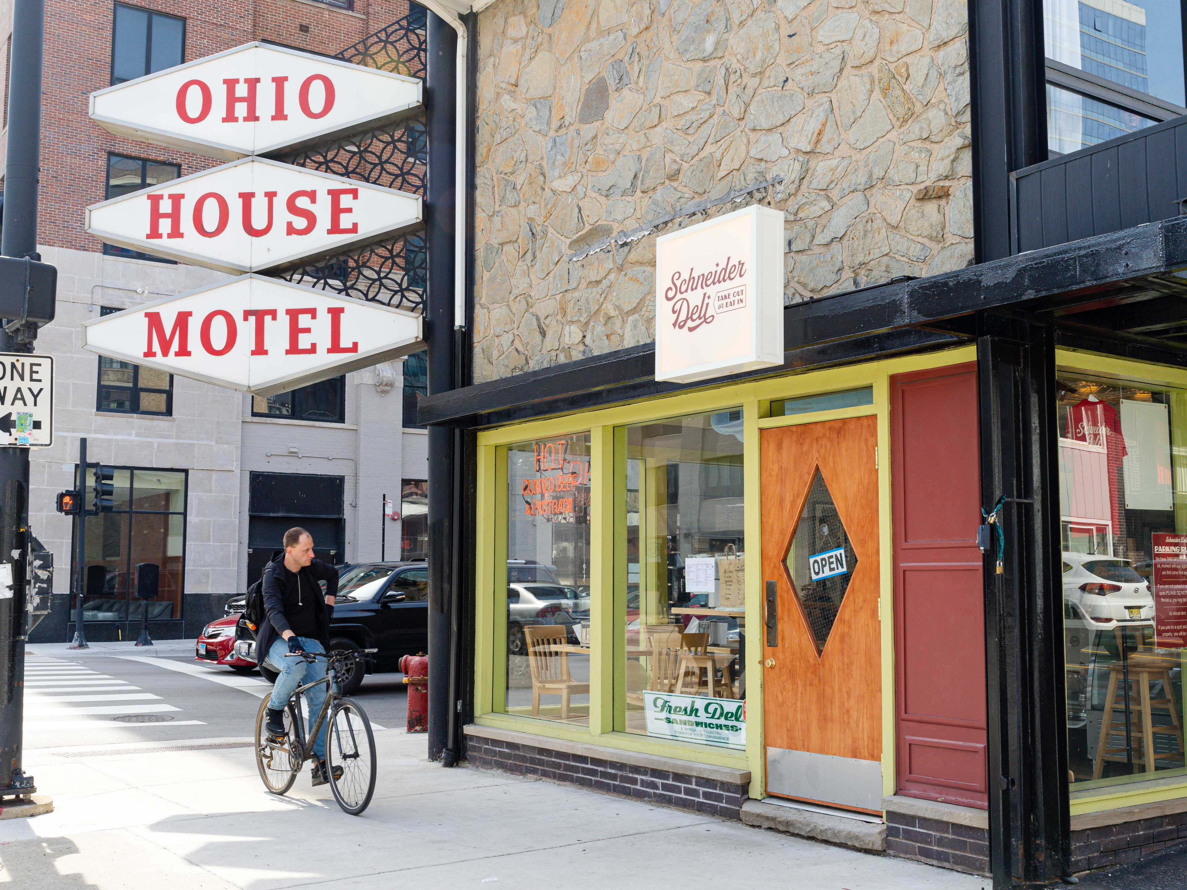 Exterior of Schneider Deli with large Ohio House Motel sign in front