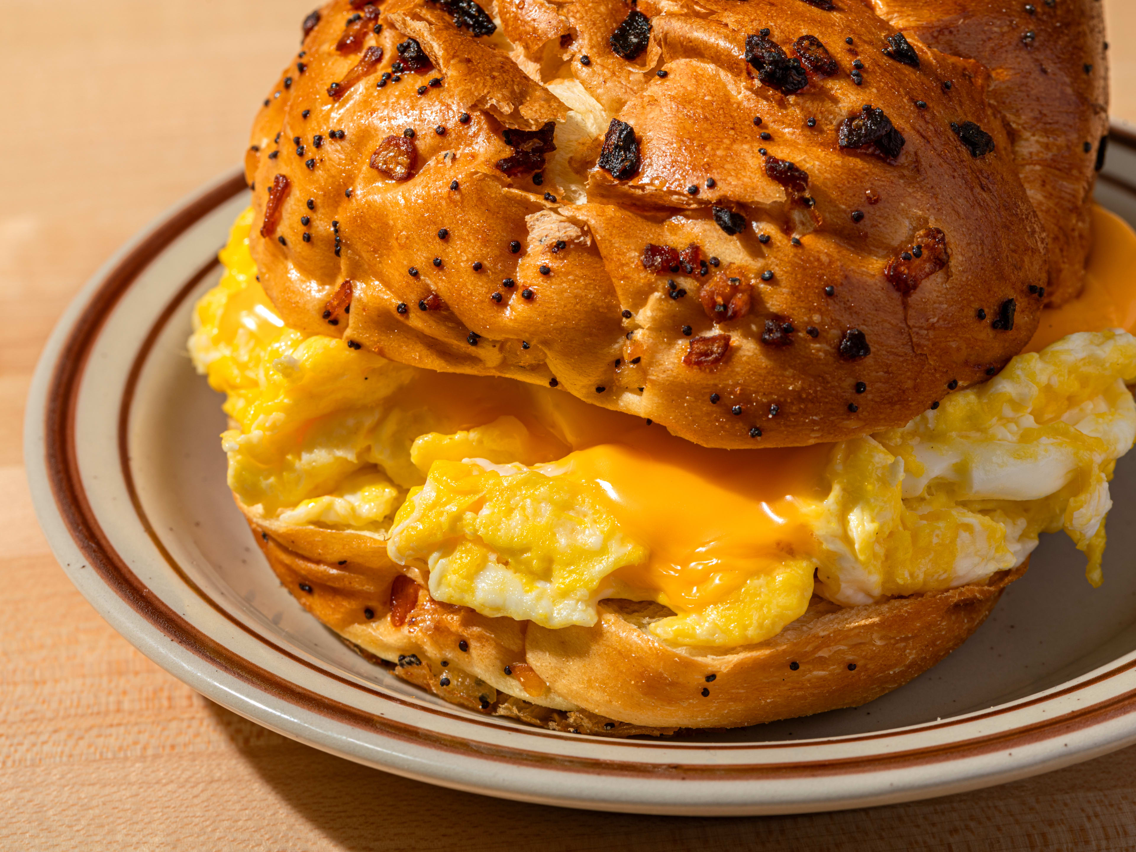 Close-up shot of an egg and cheese sandwich on a roll