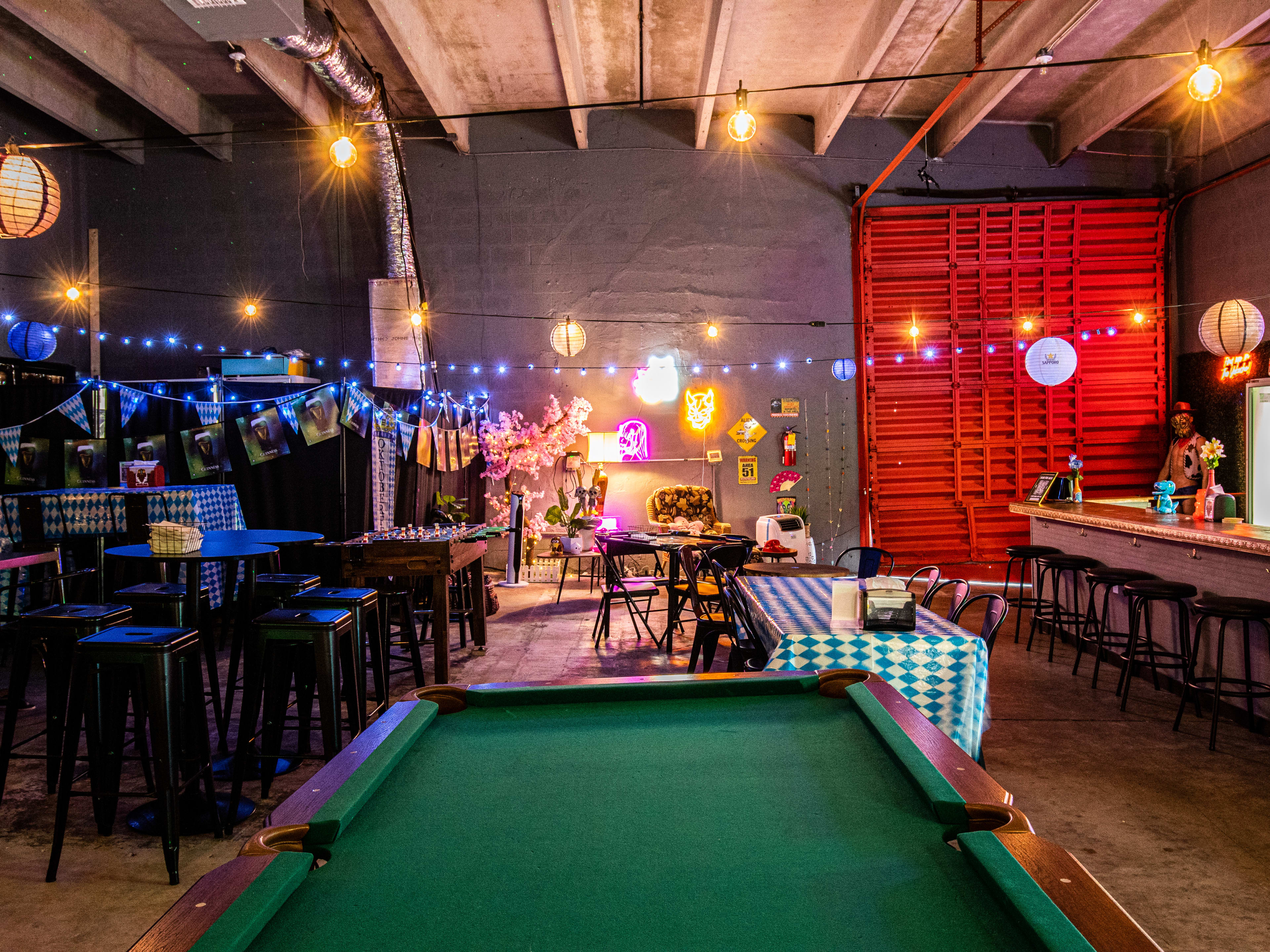 A pool table next to chairs.