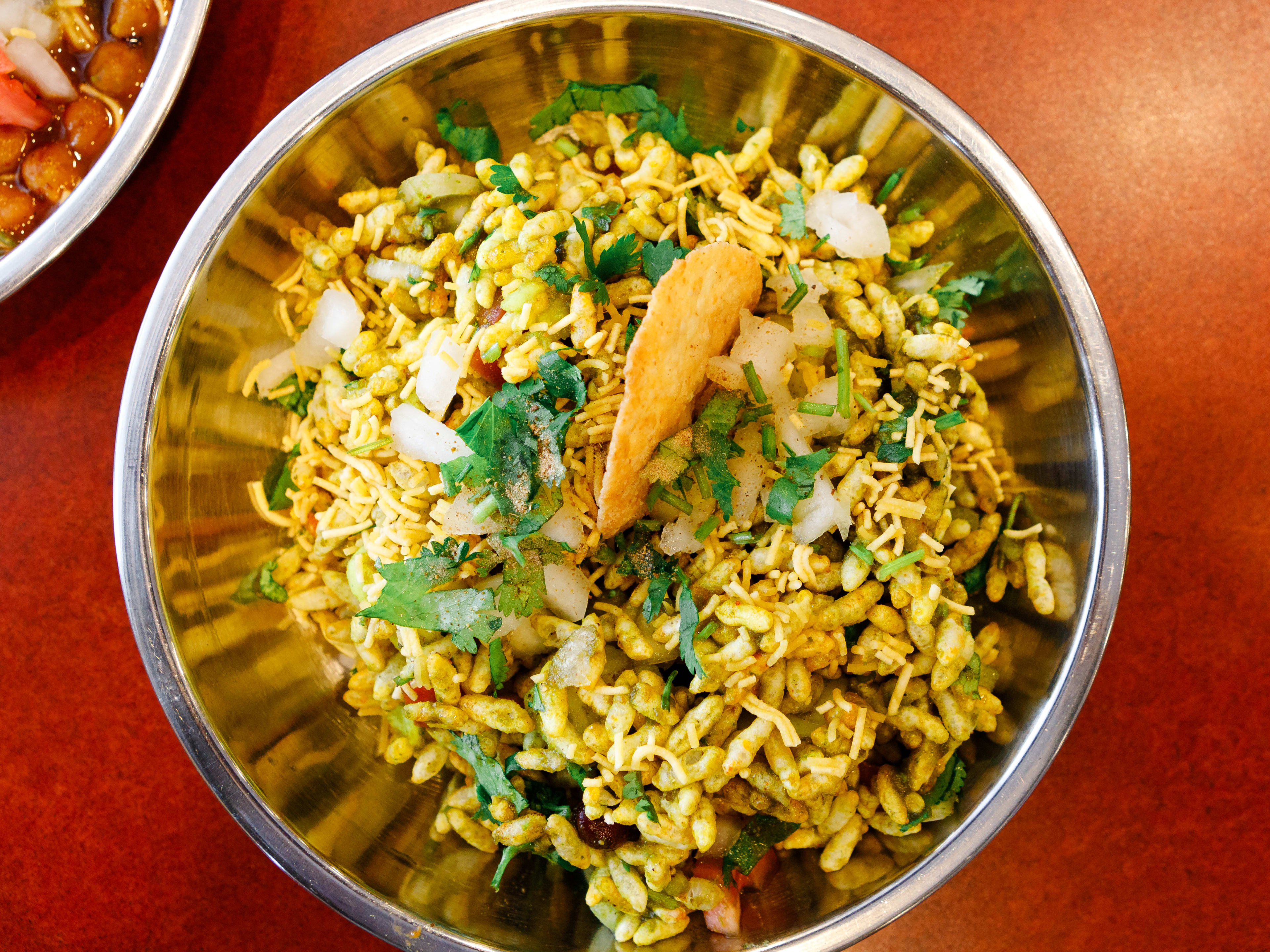 The bhel puri from Shri Balaji Bhavan served in a metal bowl.