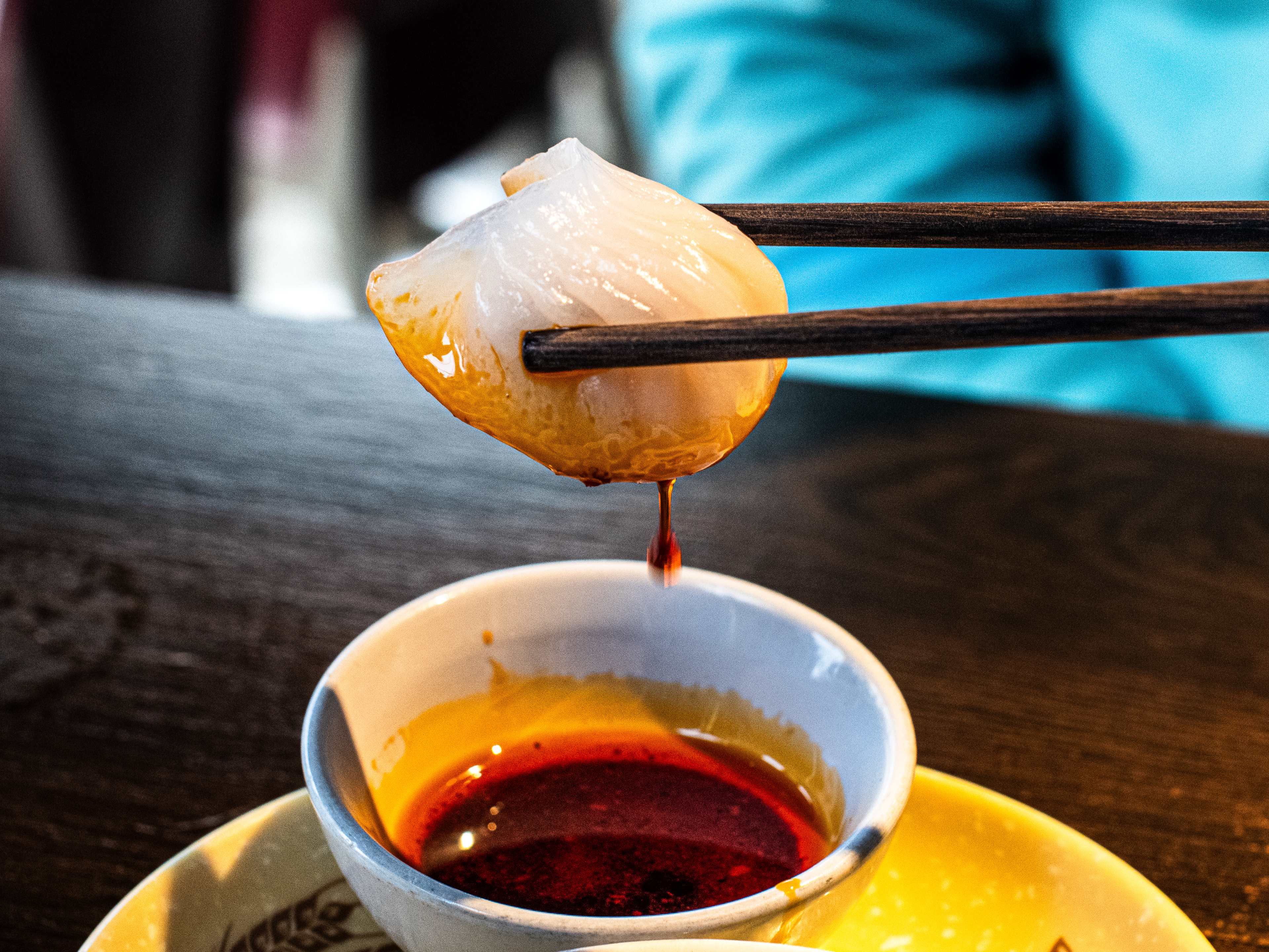 A prawn and scallop dumpling dipped in sauce at Sichuan Popo.