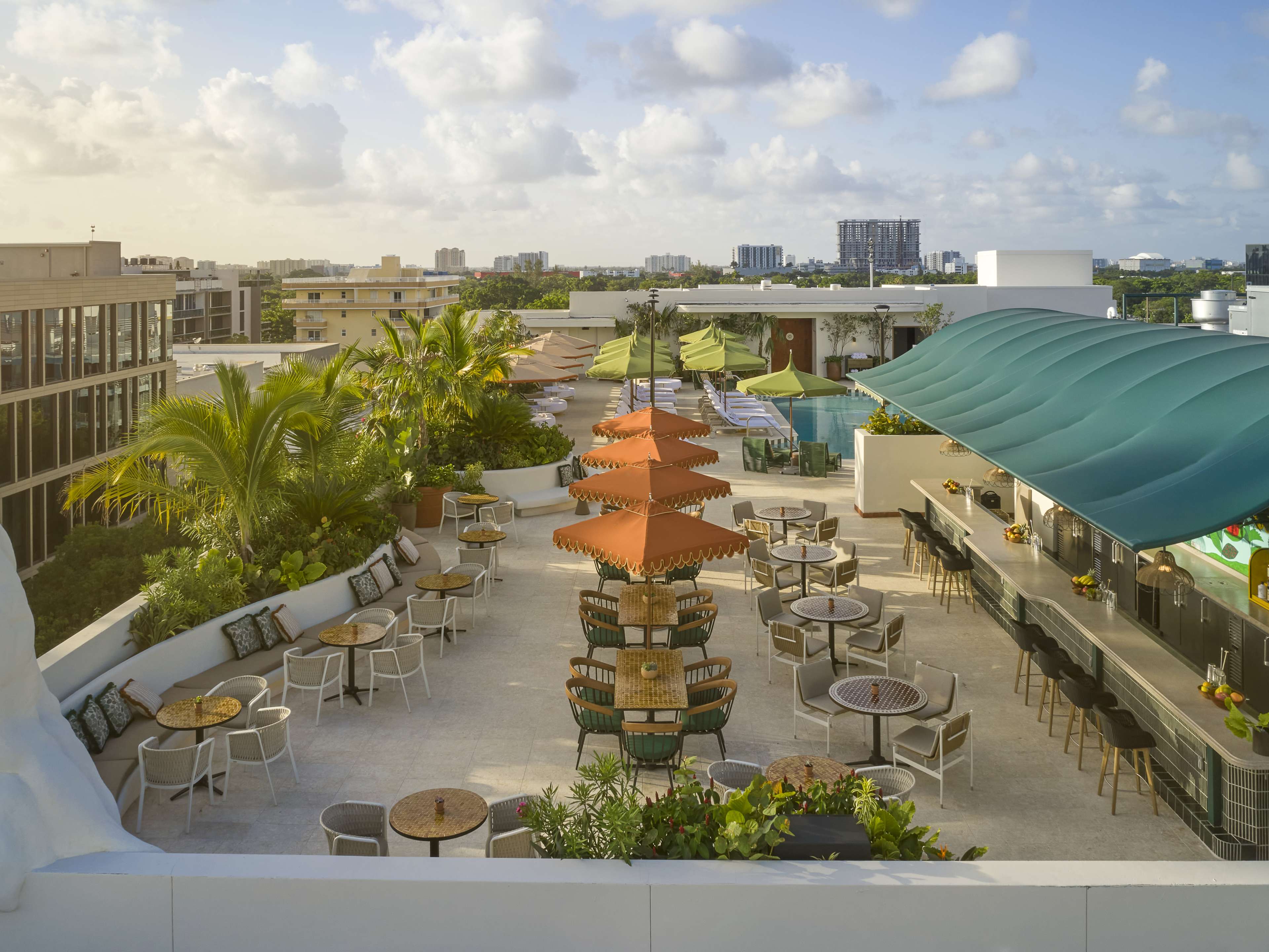 aerial shot of hotel rooftop with bar area and pool