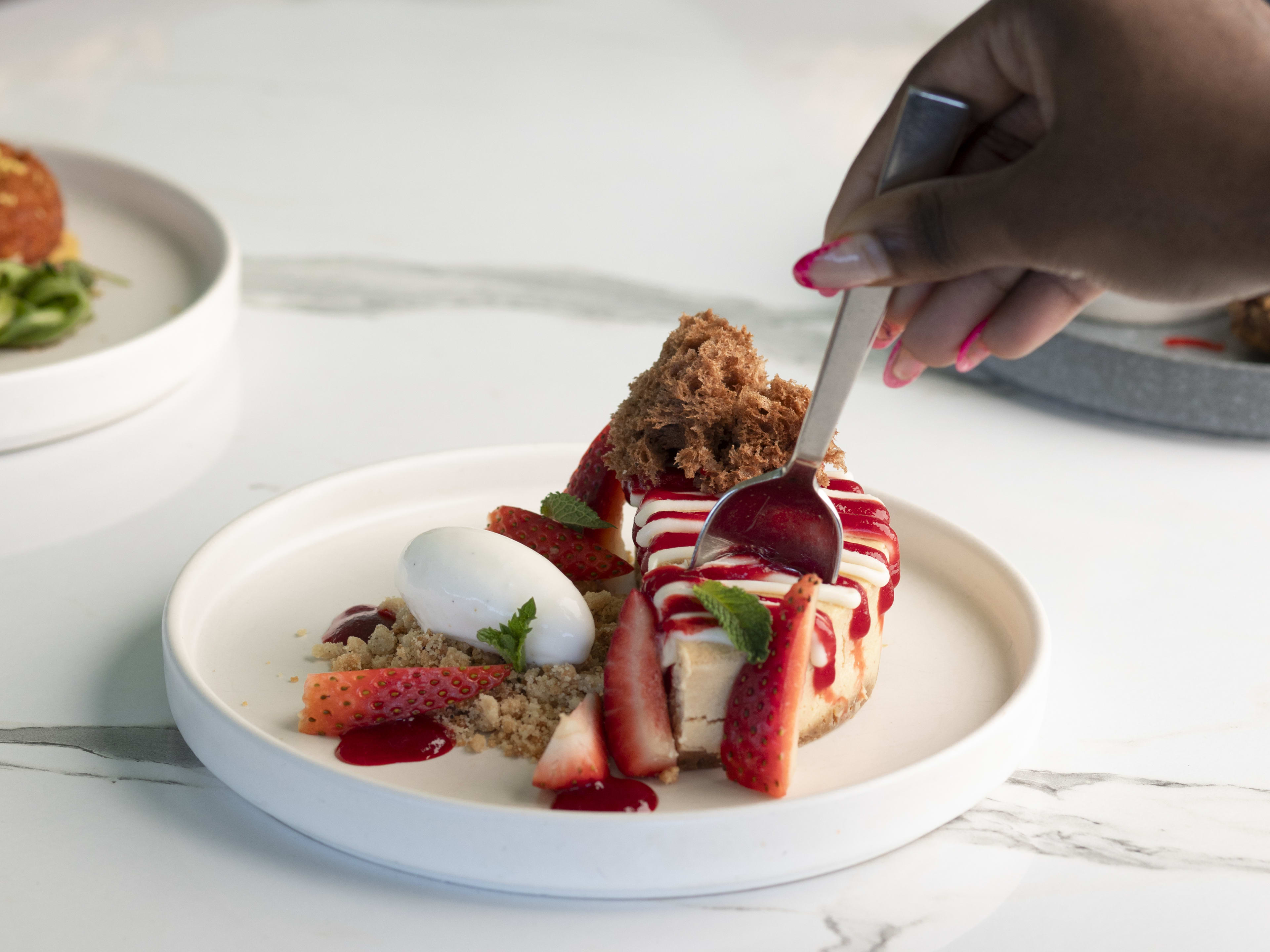 Strawberry cheesecake with side of whipped cream at Solemar