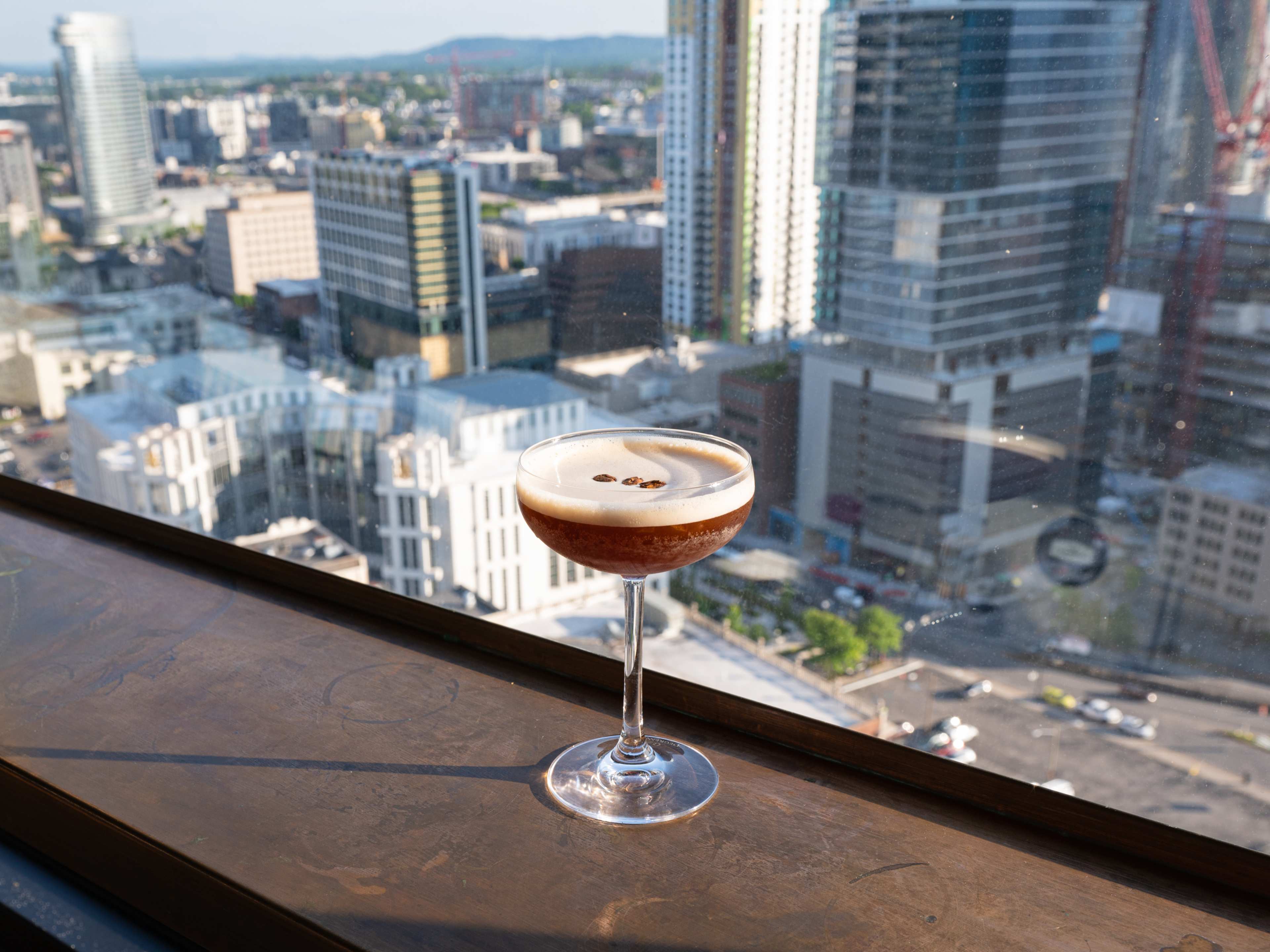 A cocktail with a view of the Nashville skyline at Sora.