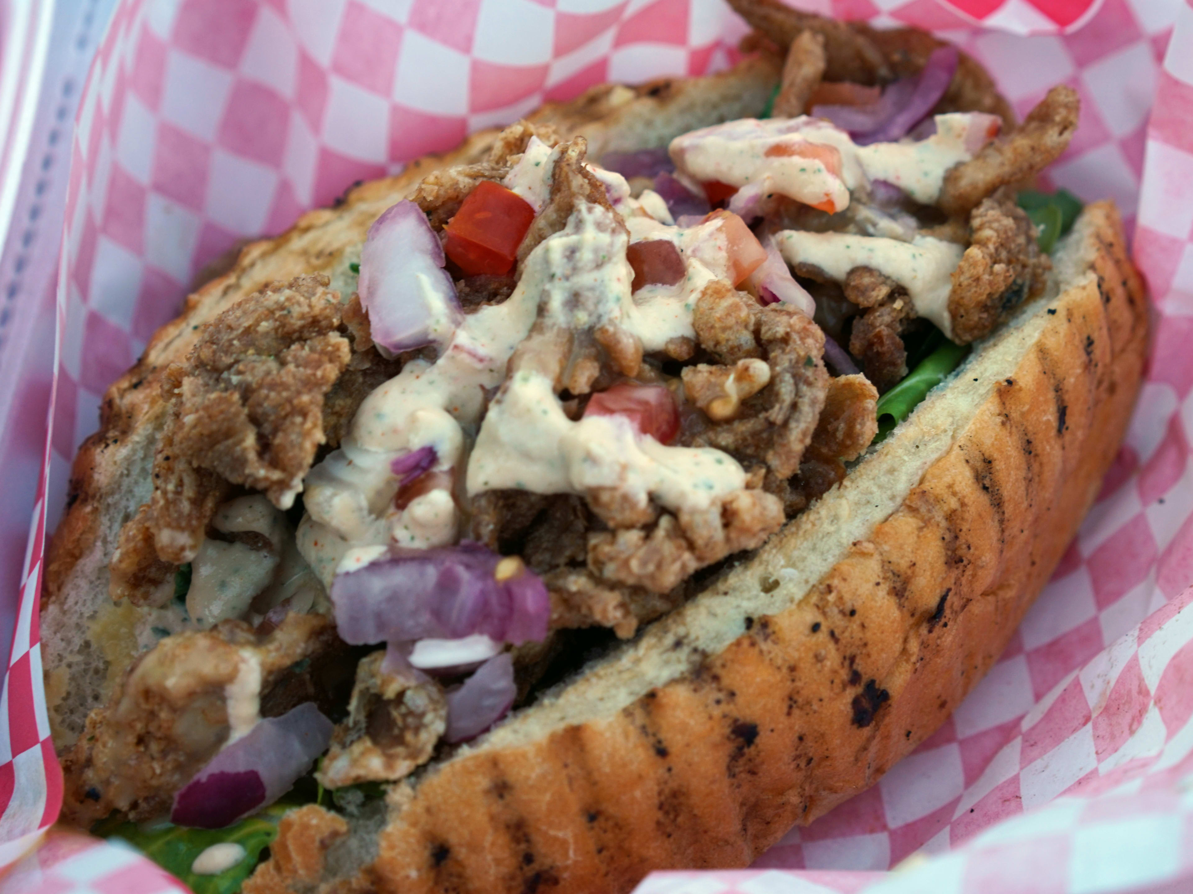 fried oyster mushroom po boy with red onions and chipotle mayo