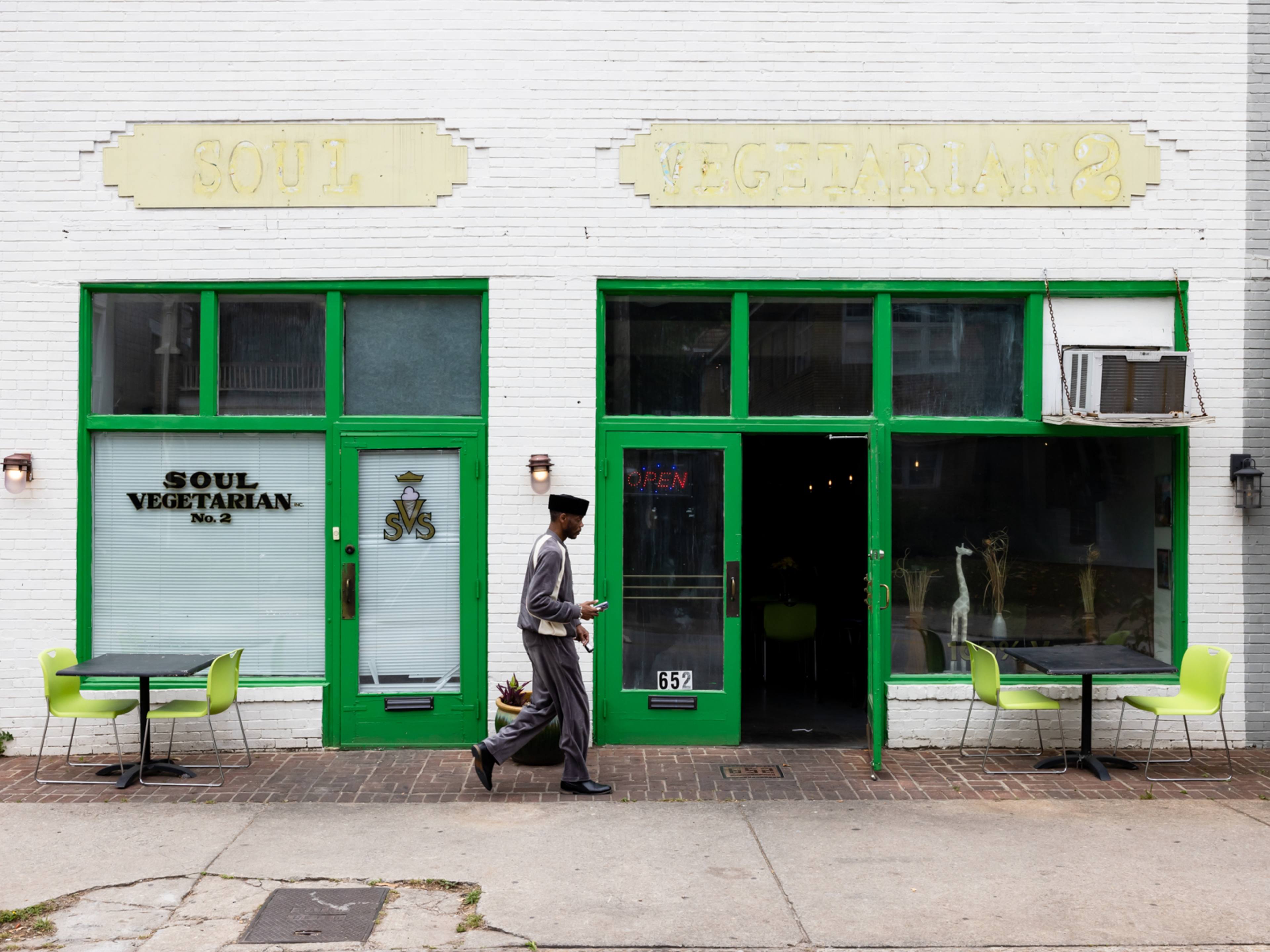 Windows with green trim and the door of Soul Vegetarian No. 2.