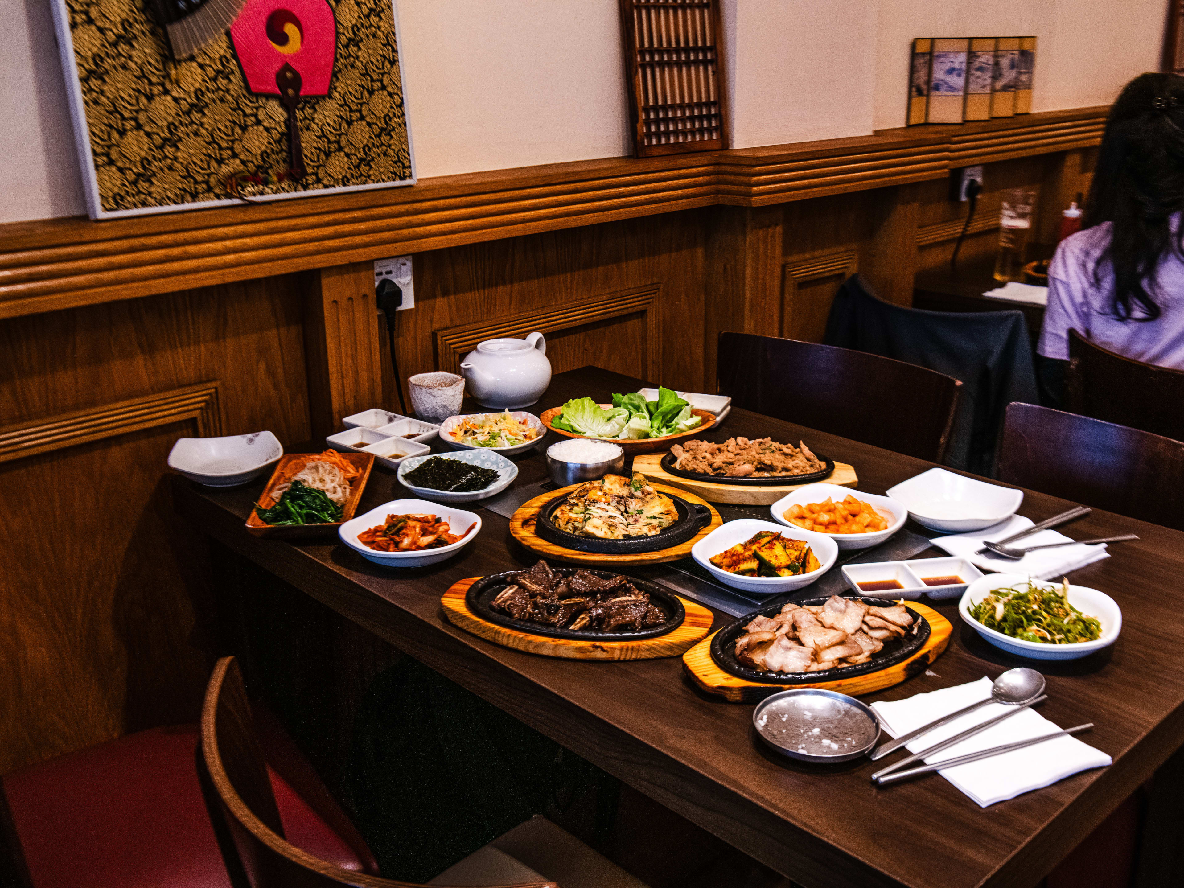 A spread of dishes take over an entire table at Spicy Grill.