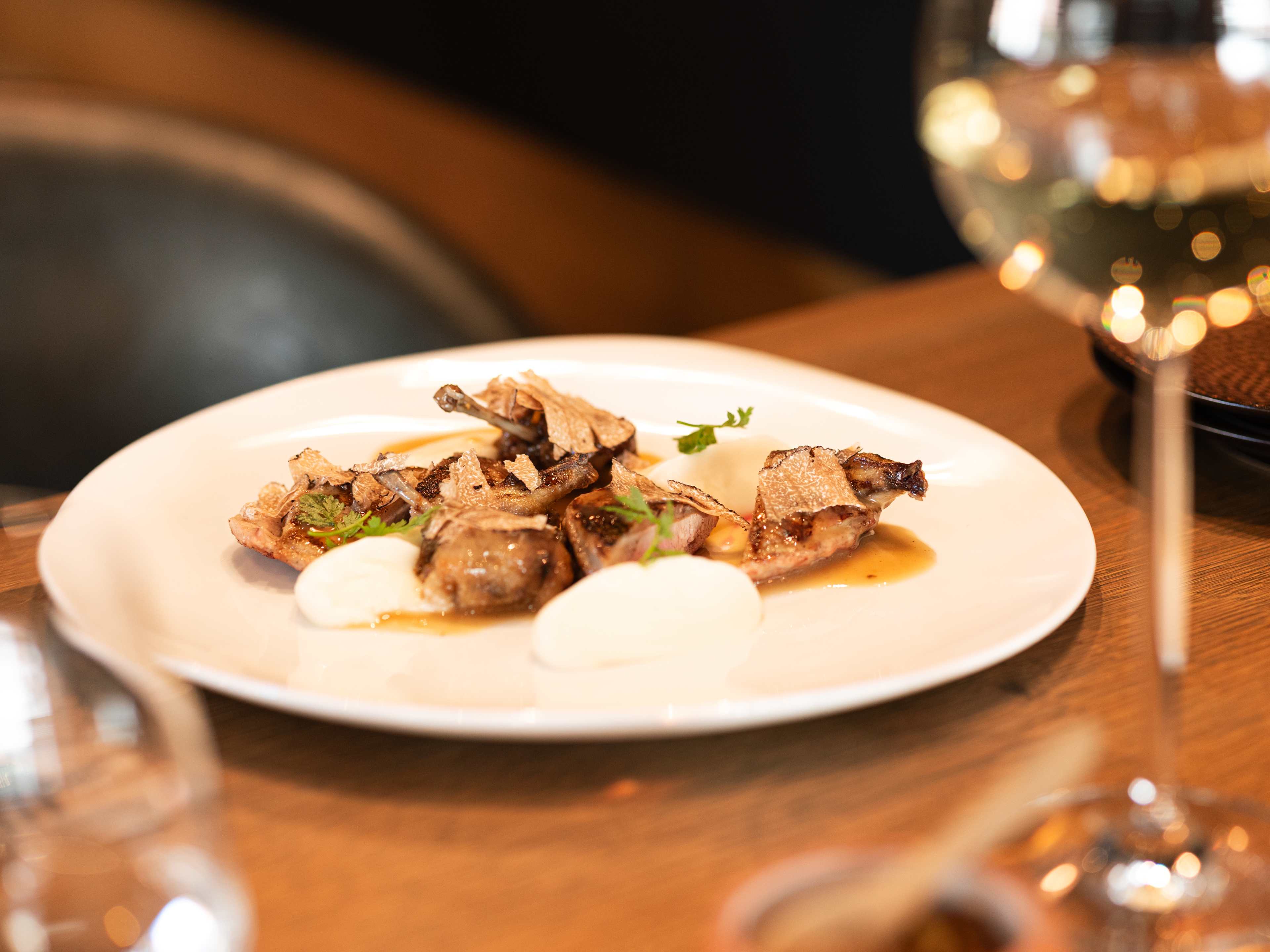 quail on plate with wine on table