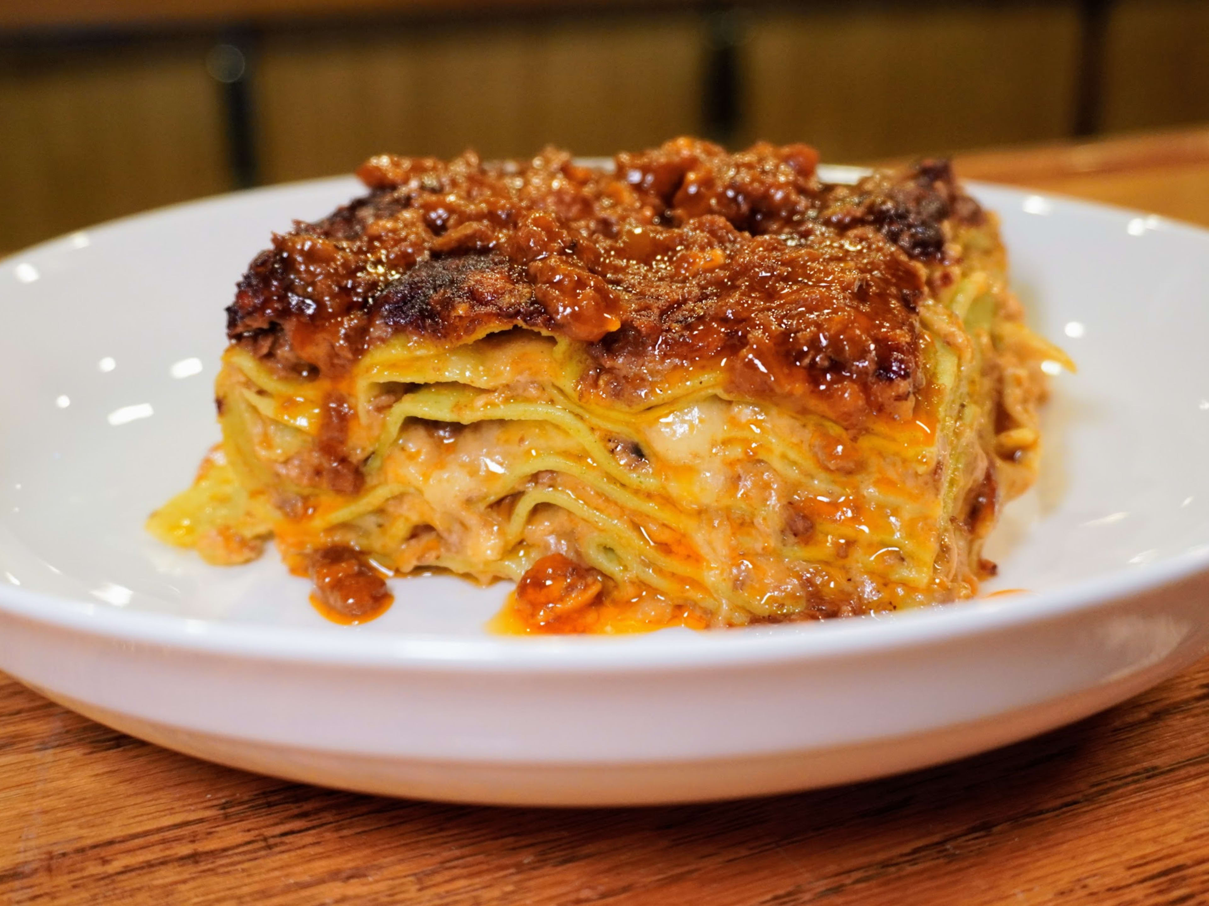 Bowl of lasagna bolognese with visible layers of pasta