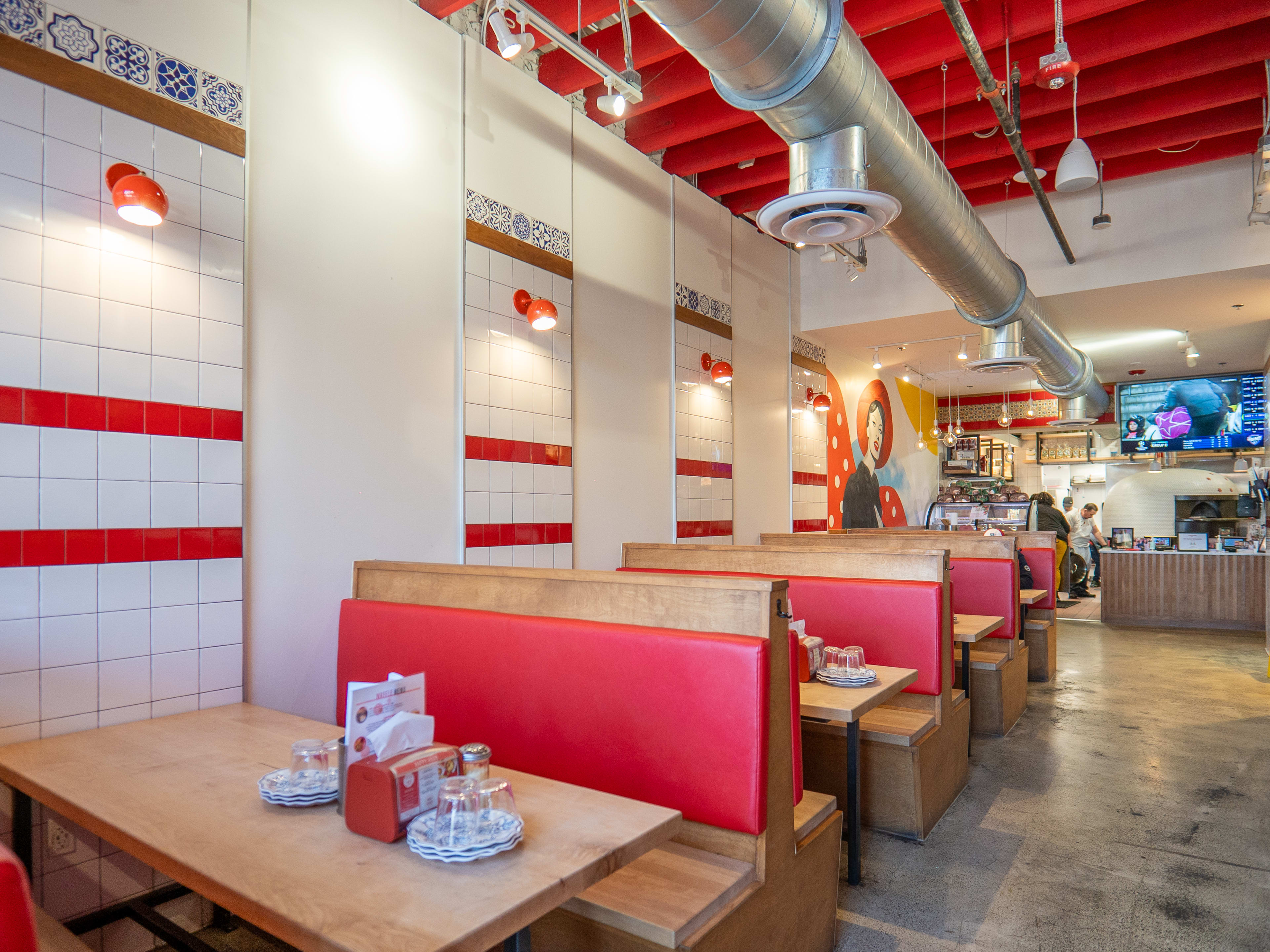 Restaurant interior with wooden booths and tiled walls