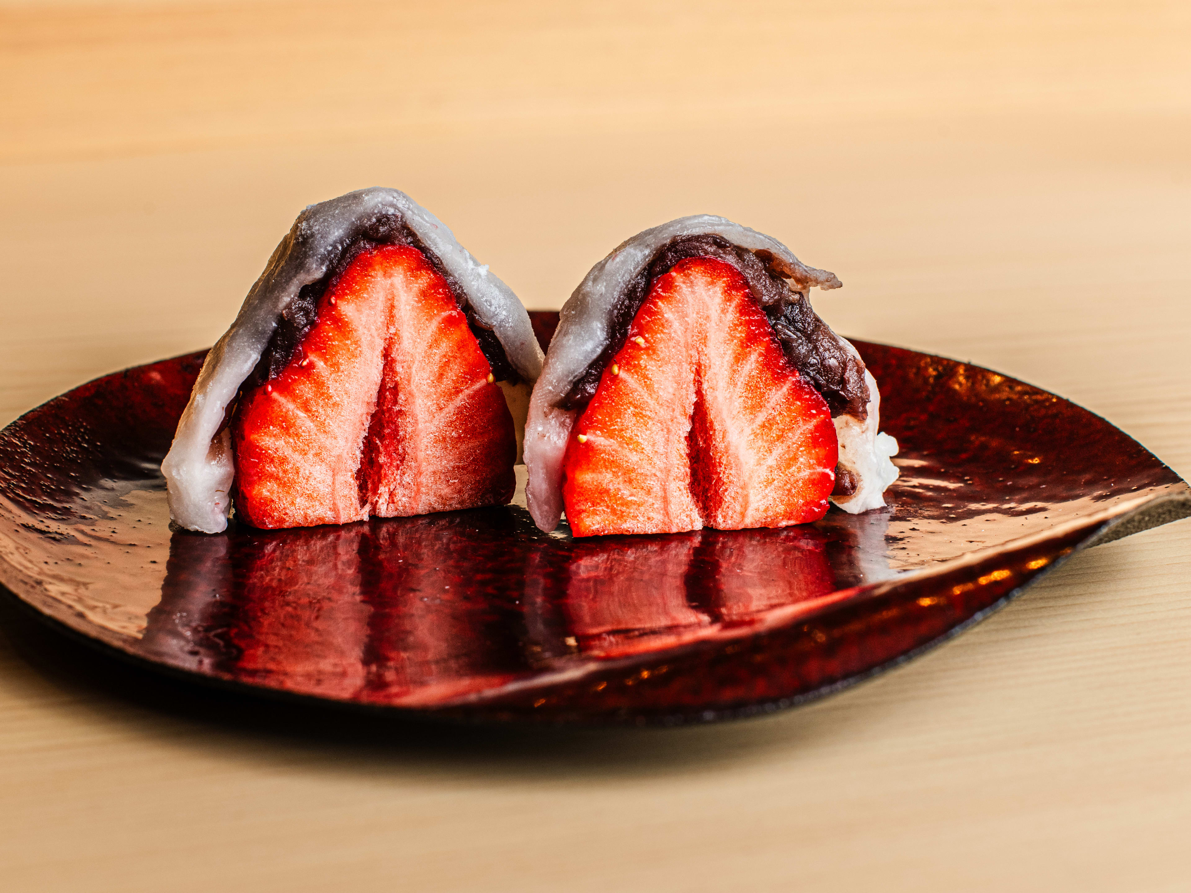 A red leaf shaped plate of daifuku.