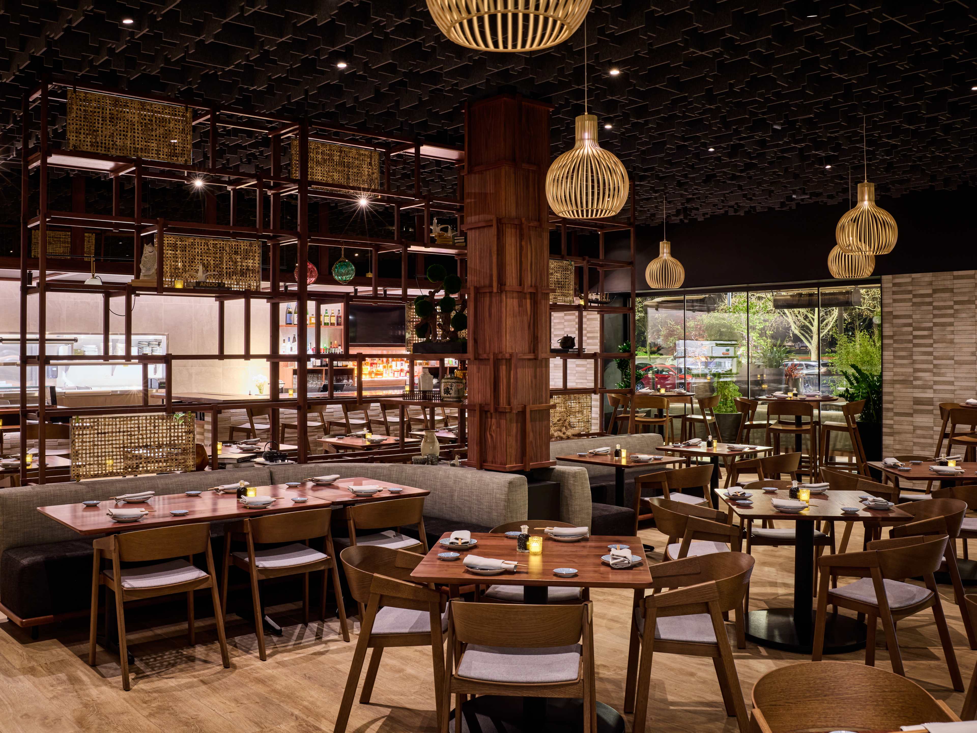 interior of restaurant with wooden shelving and hanging light fixtures