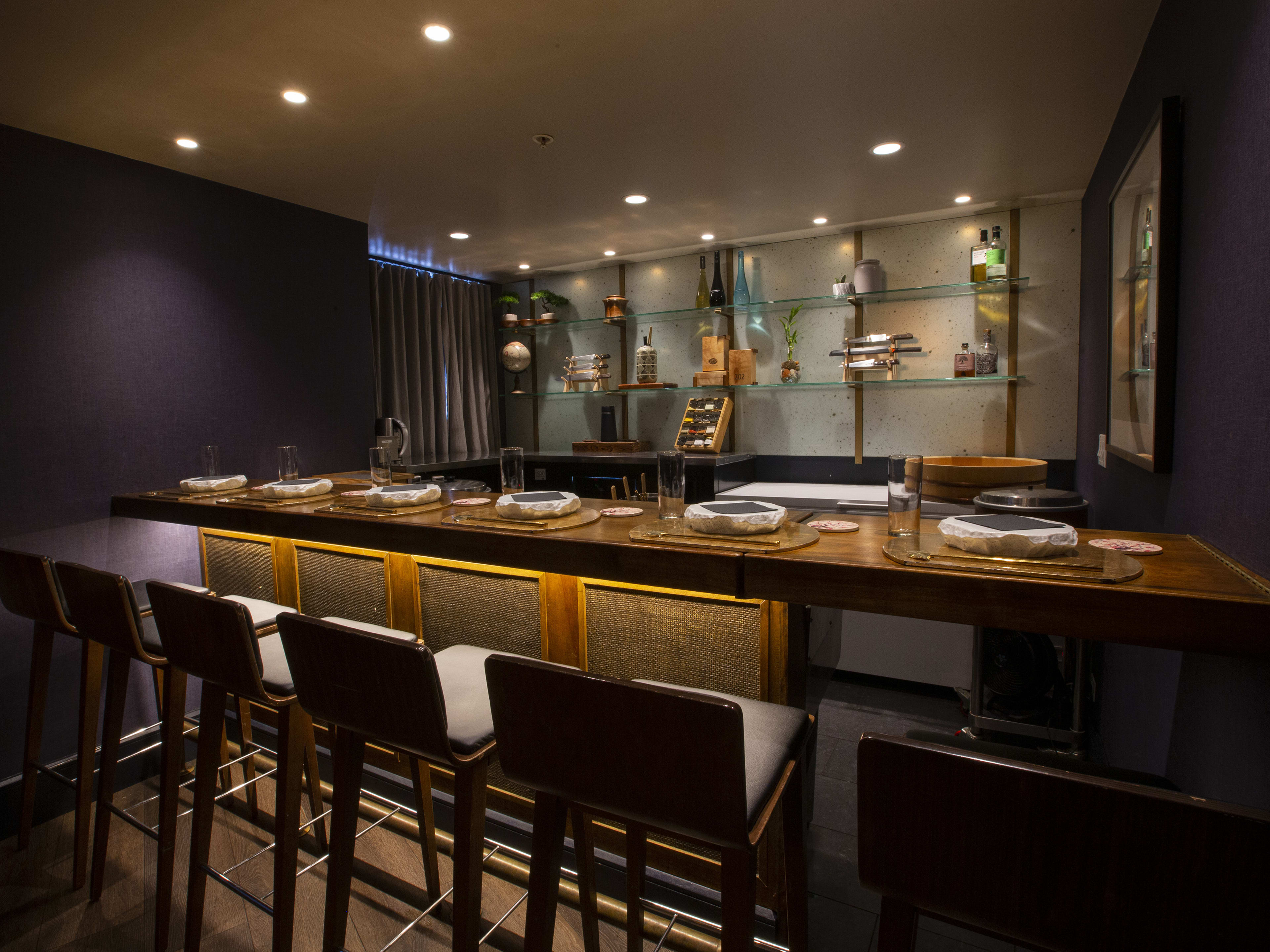 Dark sushi bar with six seats