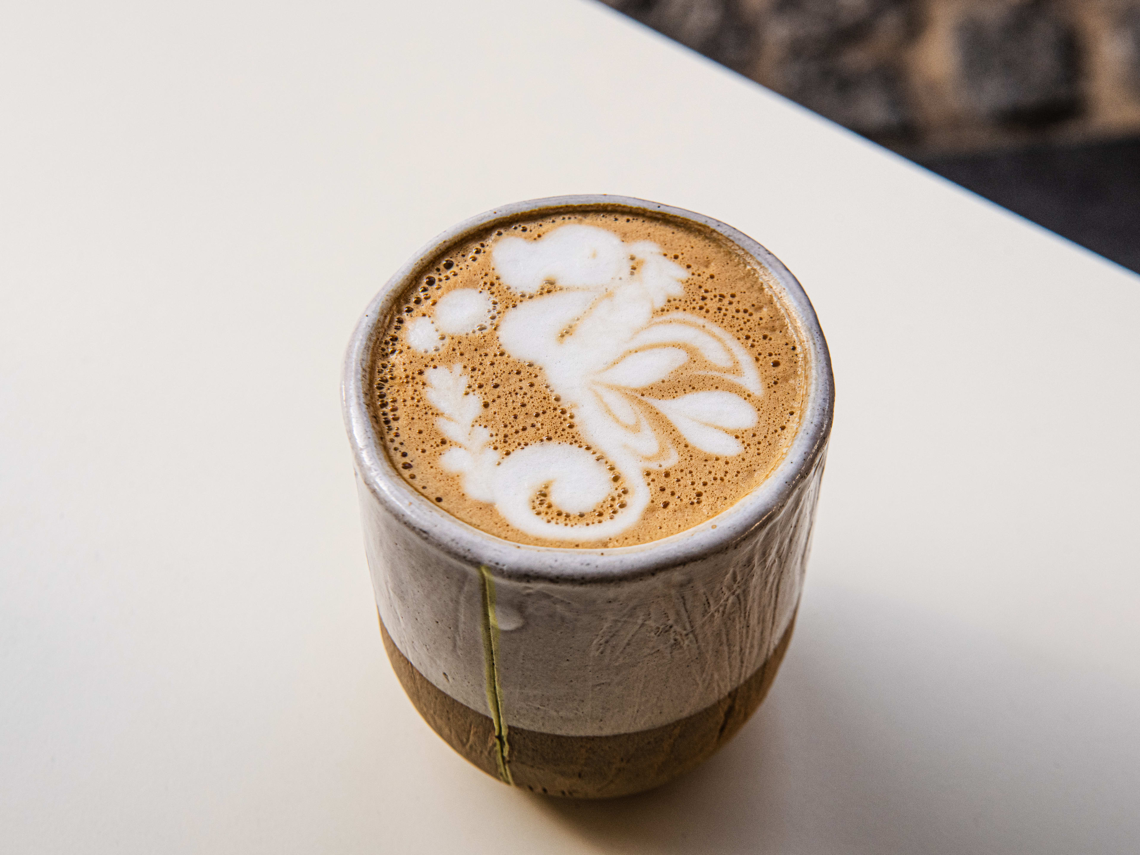 An oat milk latte from Tab x Tab with dragon latte art.