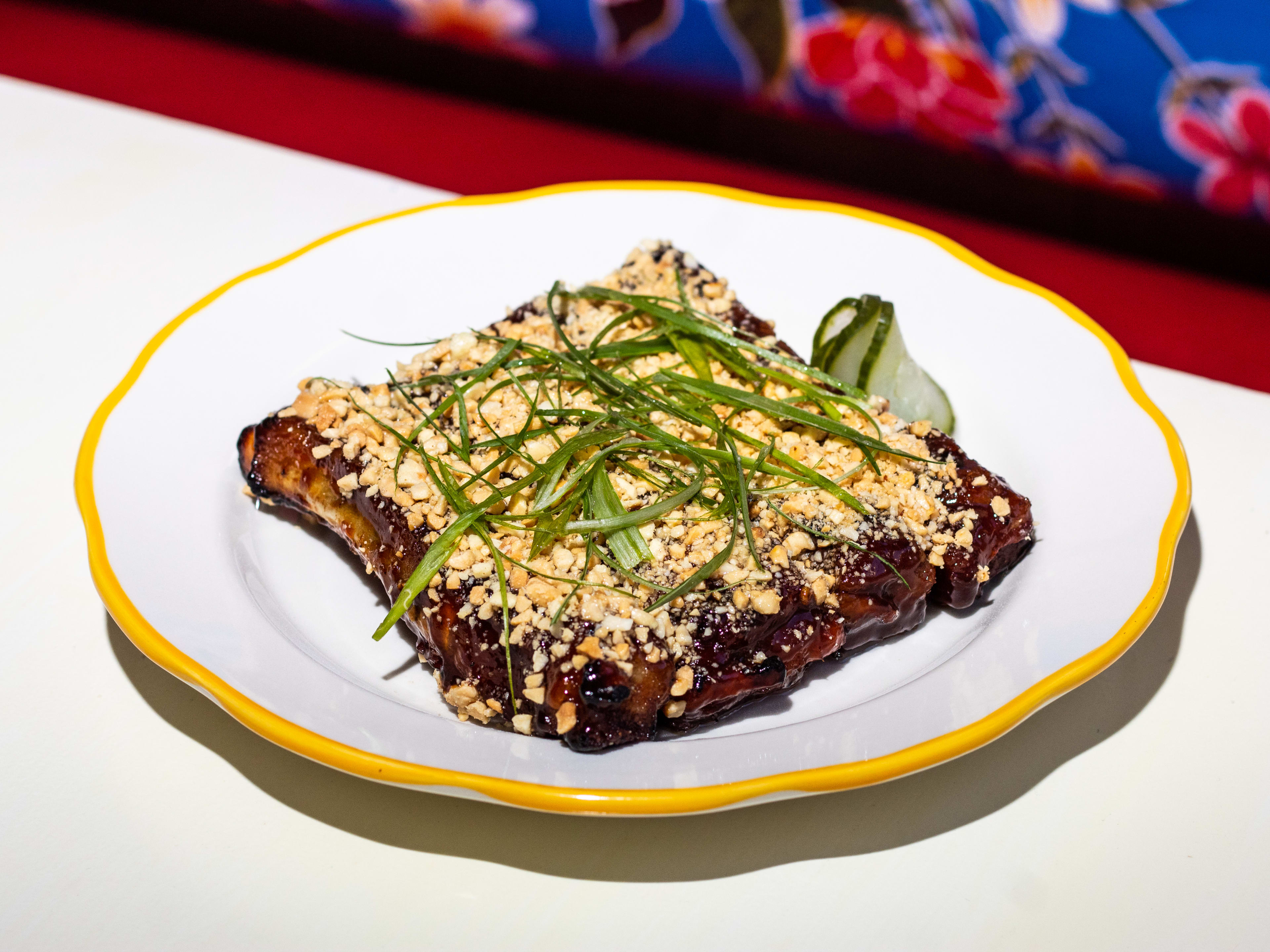 glazed ribs topped with crushed peanuts and scallion garnish