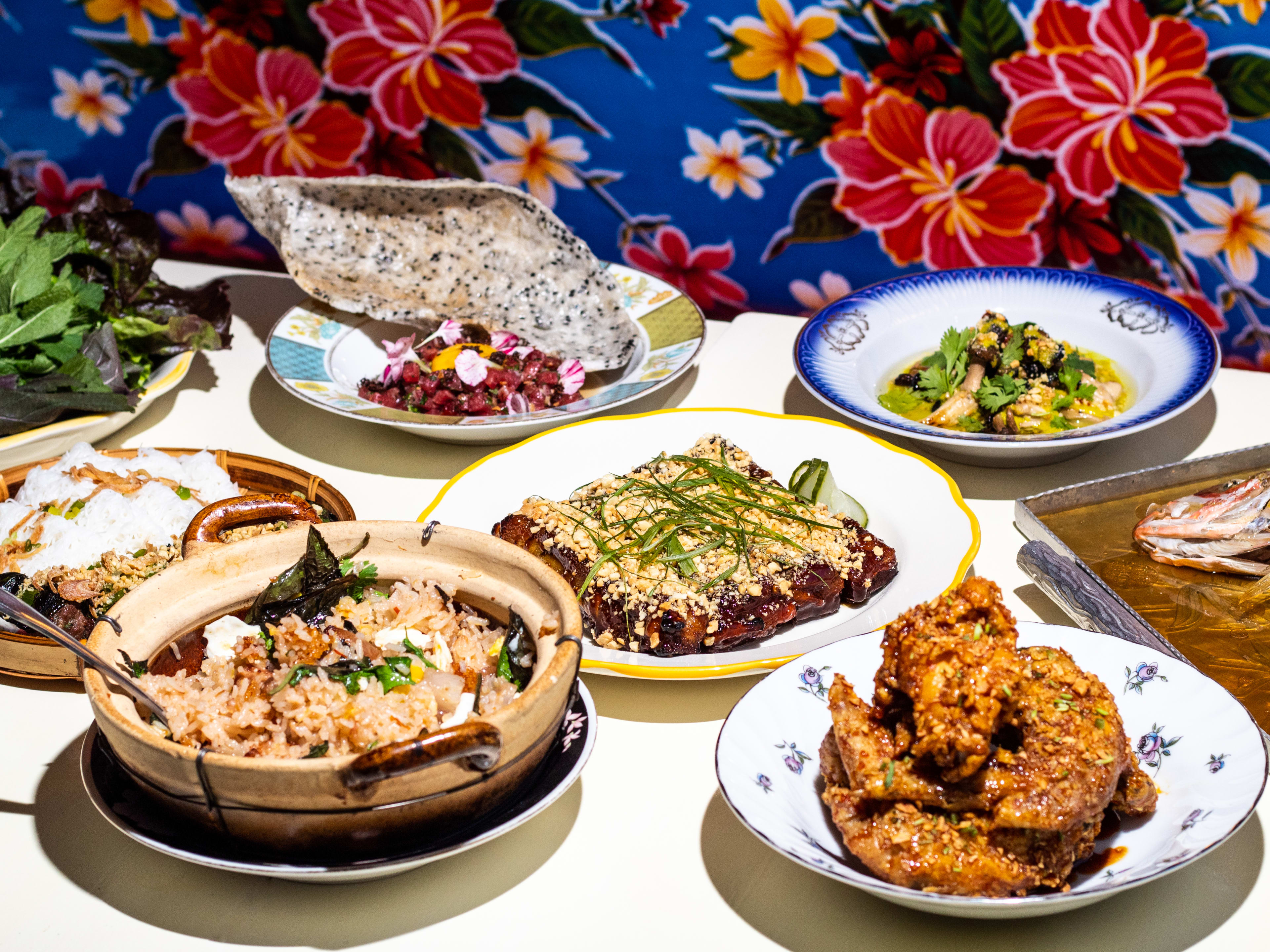 spread of dishes such as wings, tartare, rich, fish