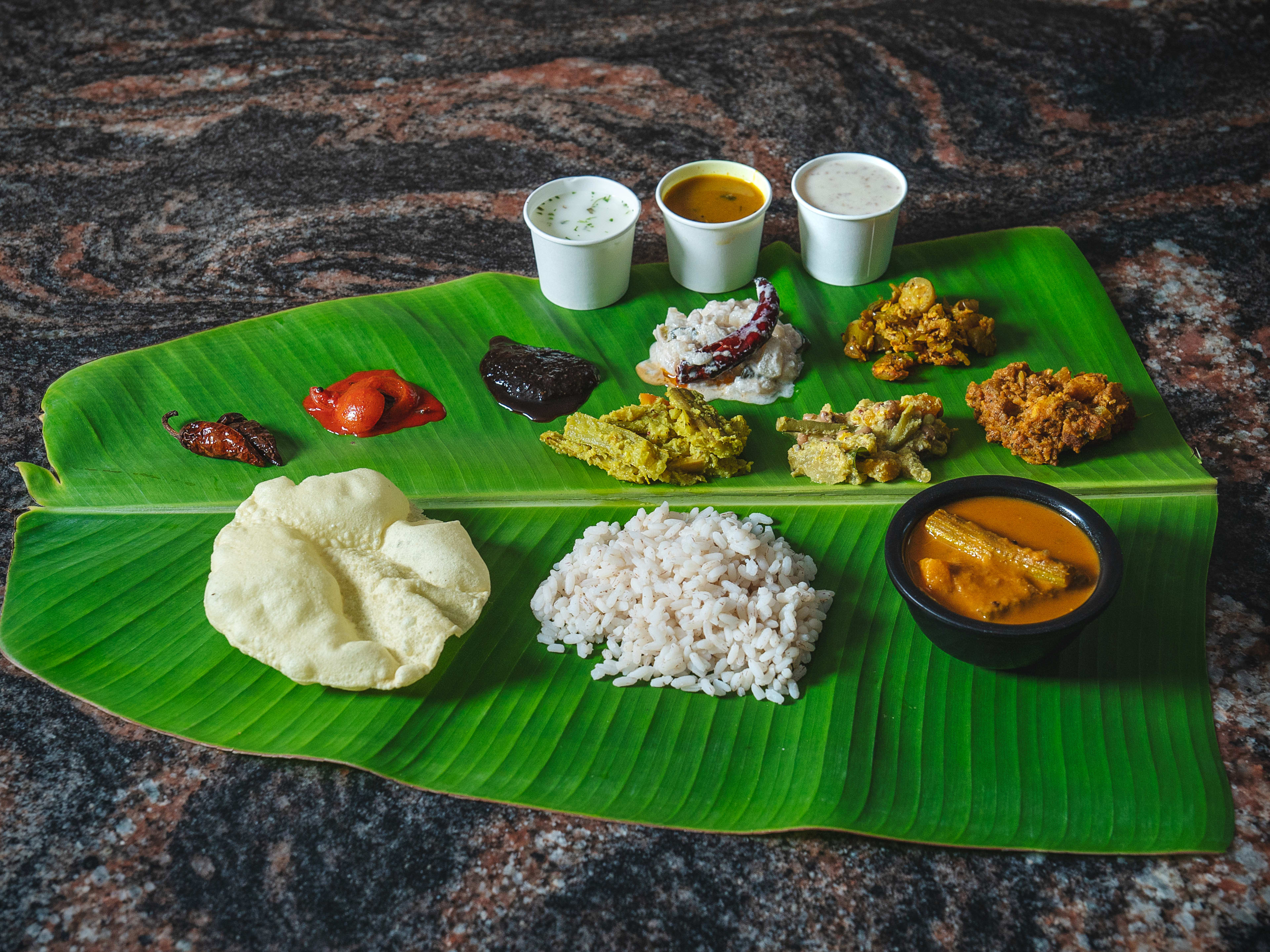 Sadya served on a banana leaf at Lalit Refreshment - Taste of Kerala