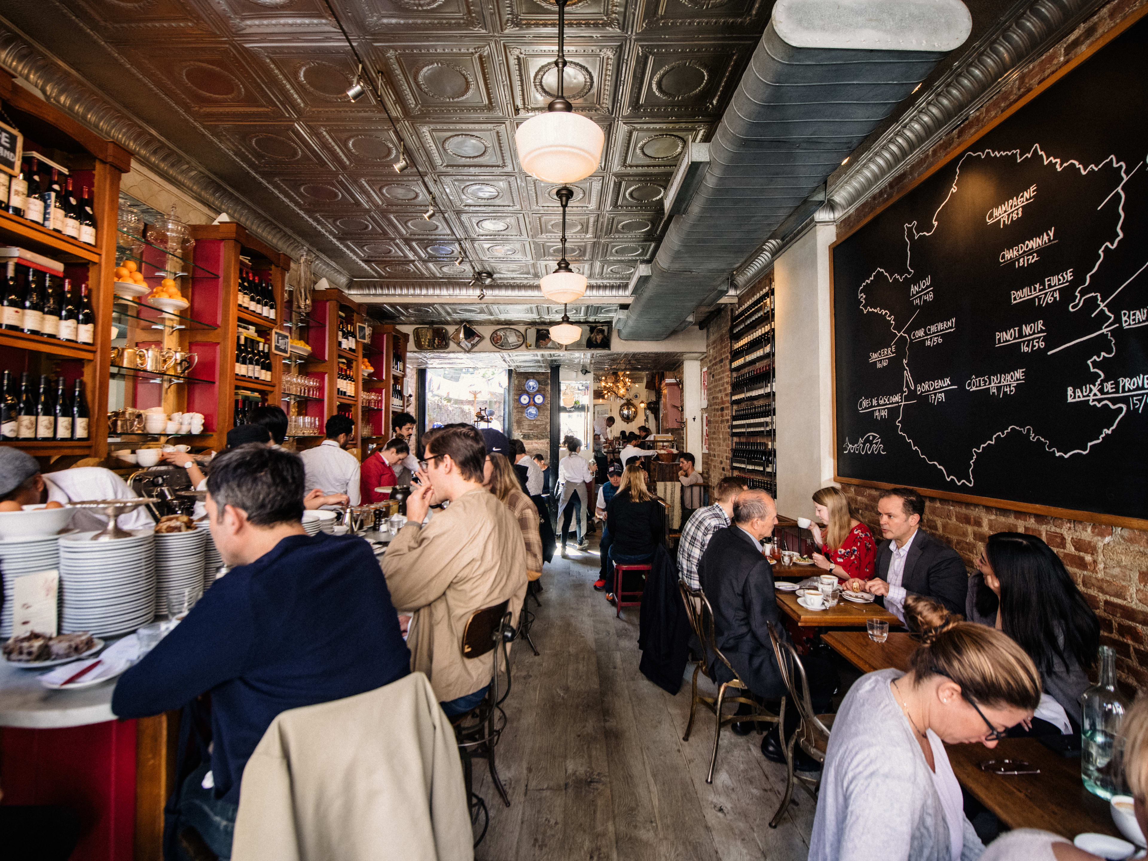 A small, crowded French restaurant with brick walls and little tables.