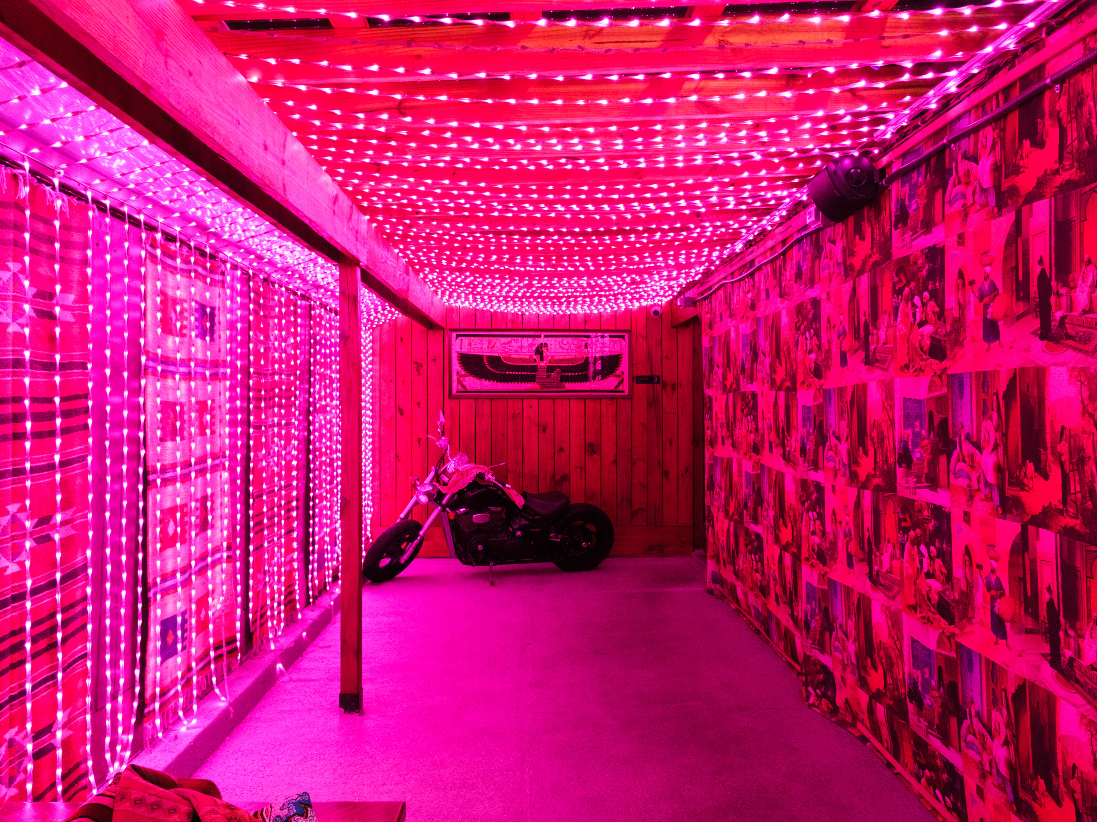 A pink string light covered room at The Tent.