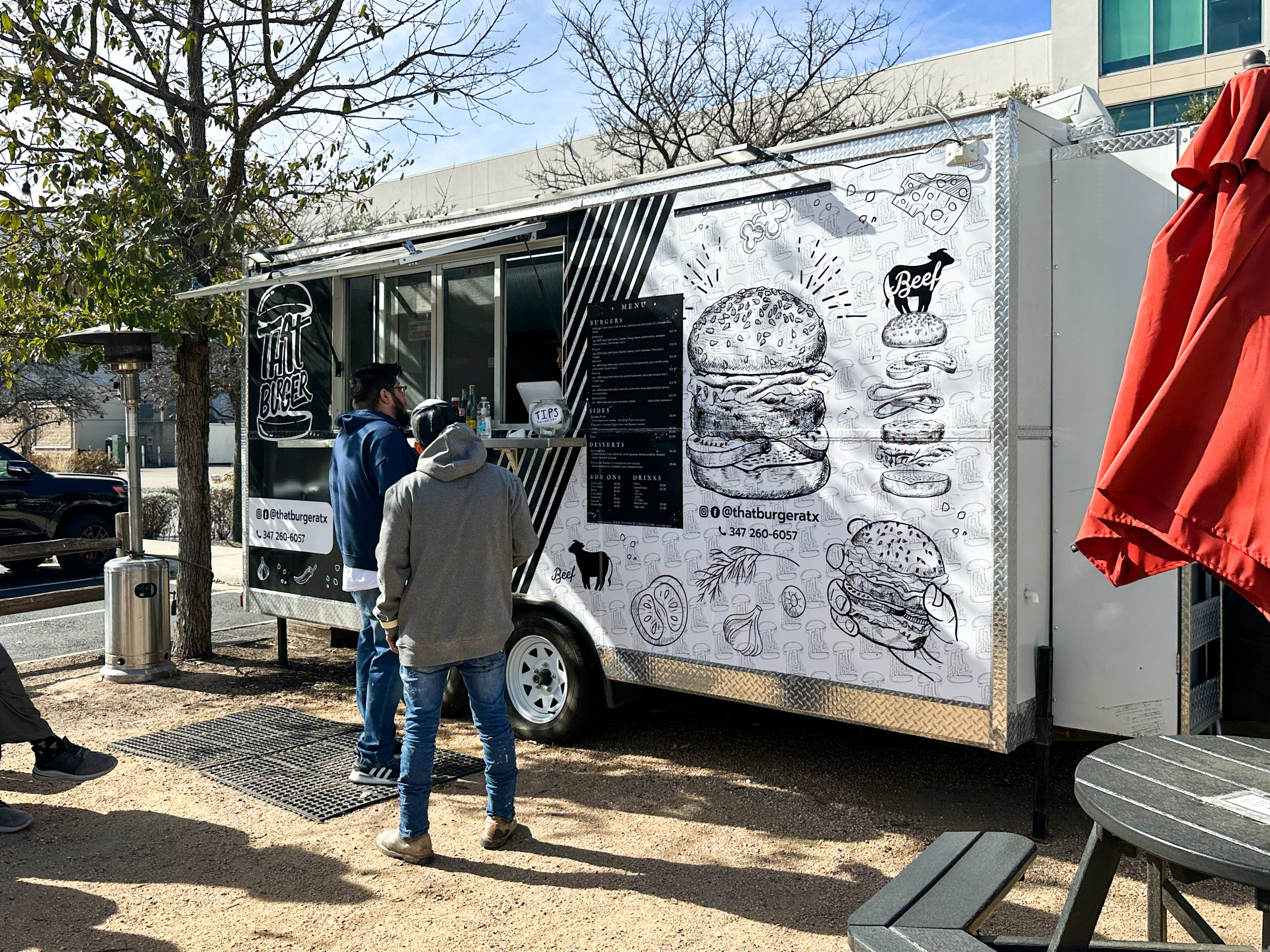 The white food truck with black illustrations from That Burger.