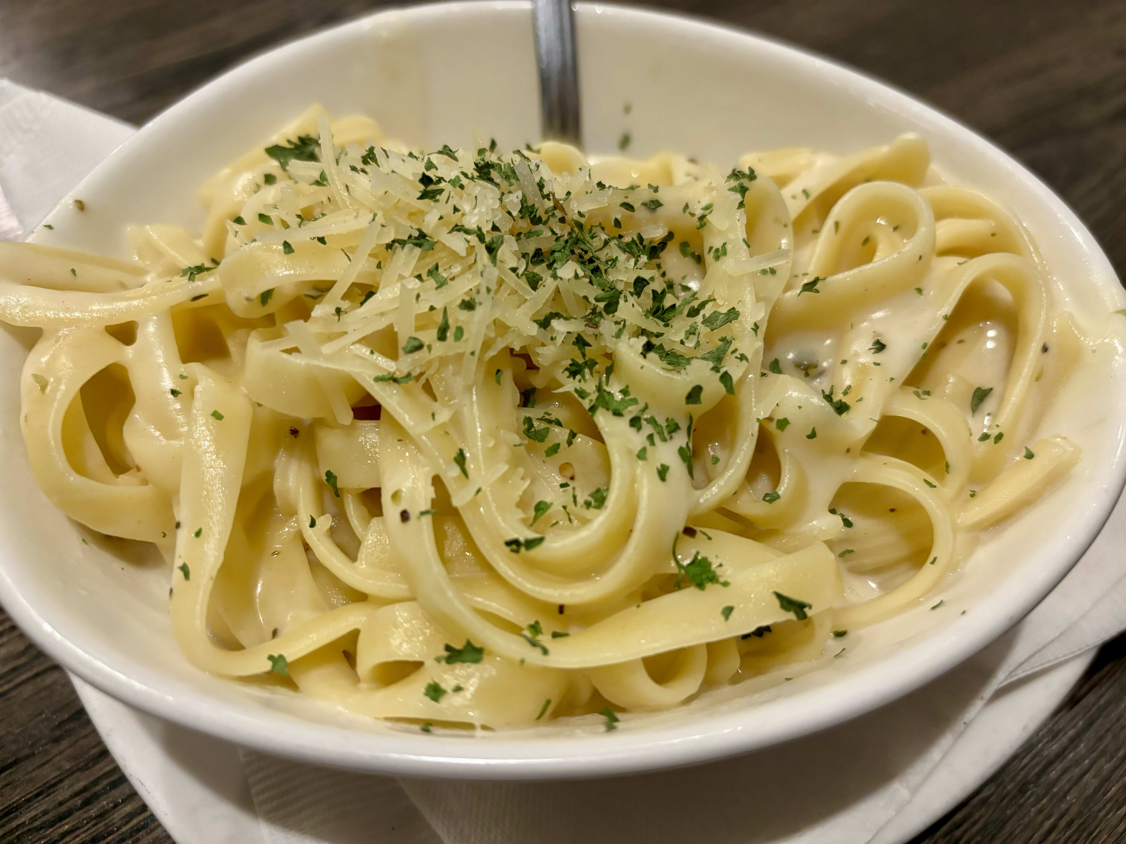 A small bowl of fettuccine alfredo.