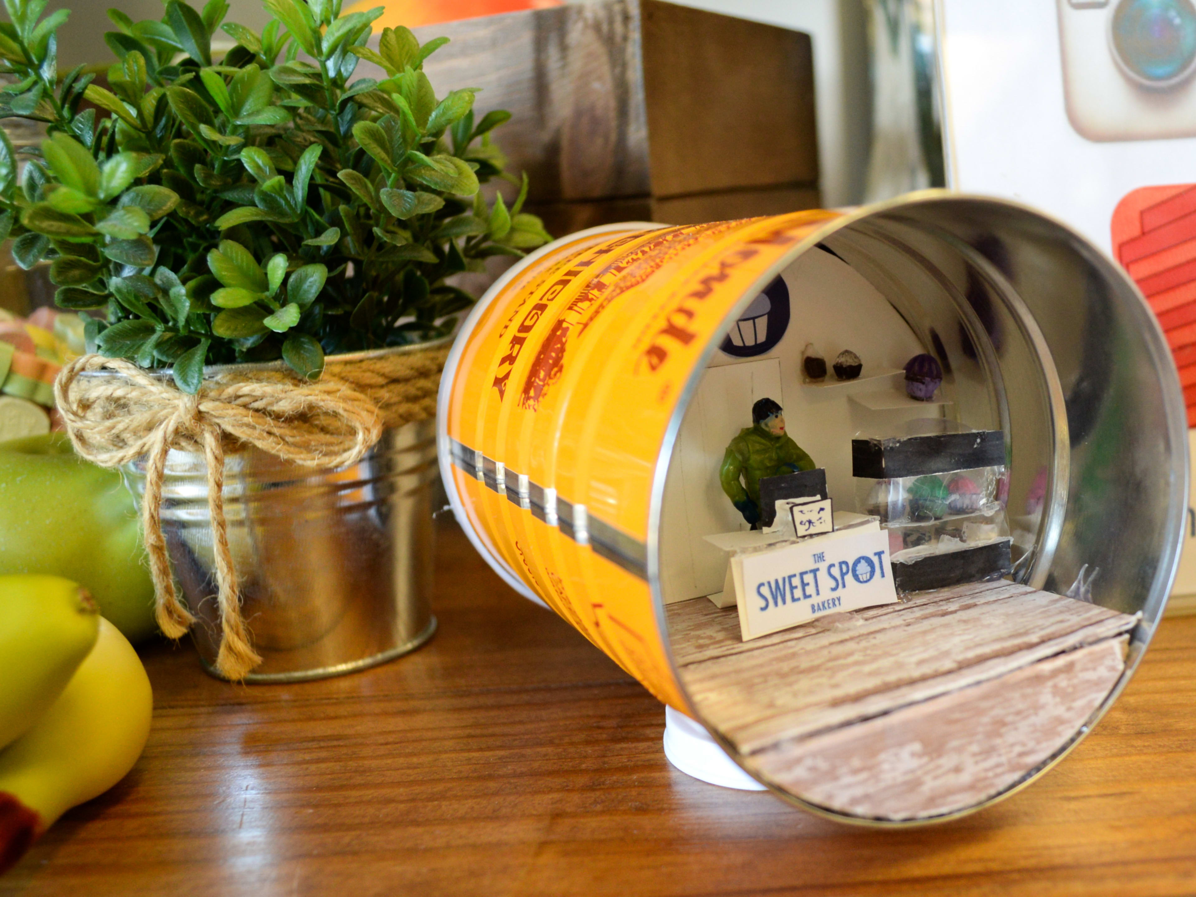 Minature model of a bakery inside a coffee can