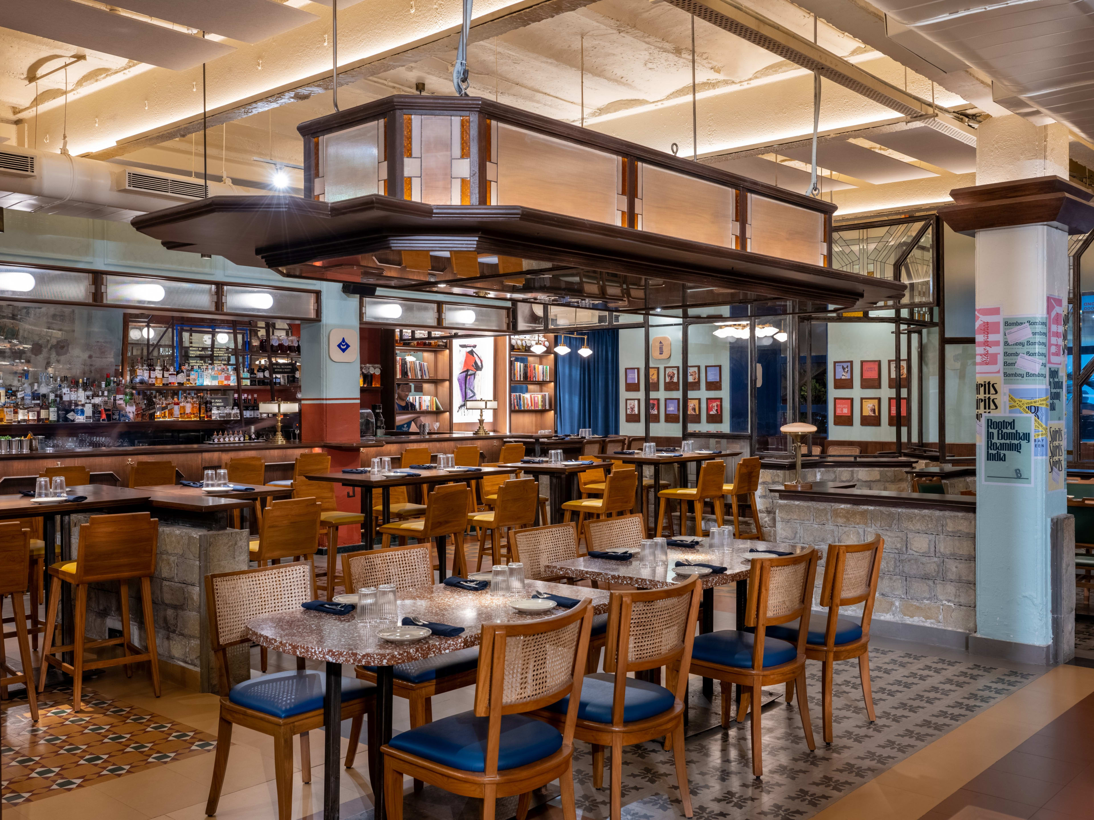 Interior dining space with a hanging light system at The Bombay Canteen