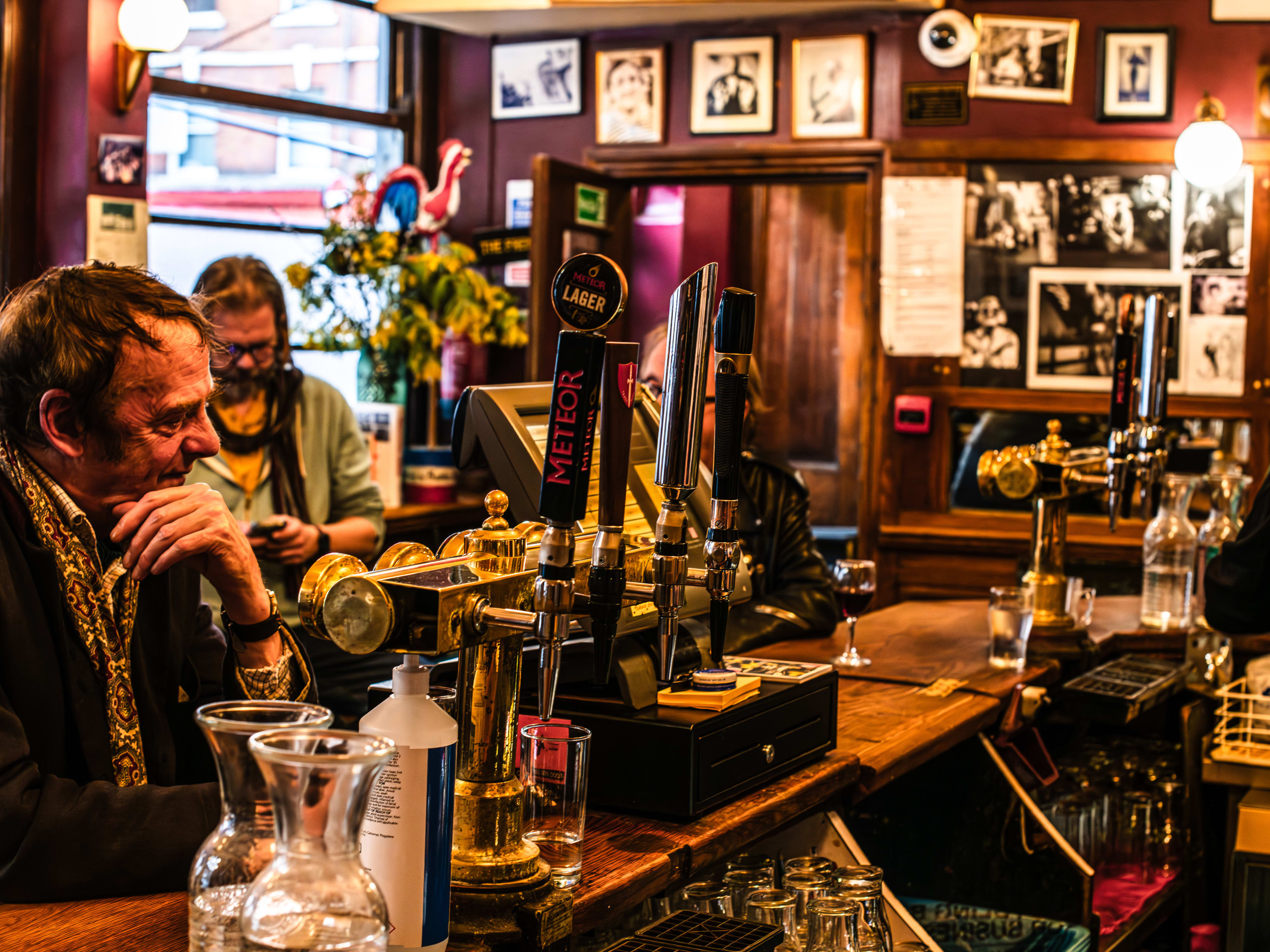 The bar at The French House with a regular sitting at it.