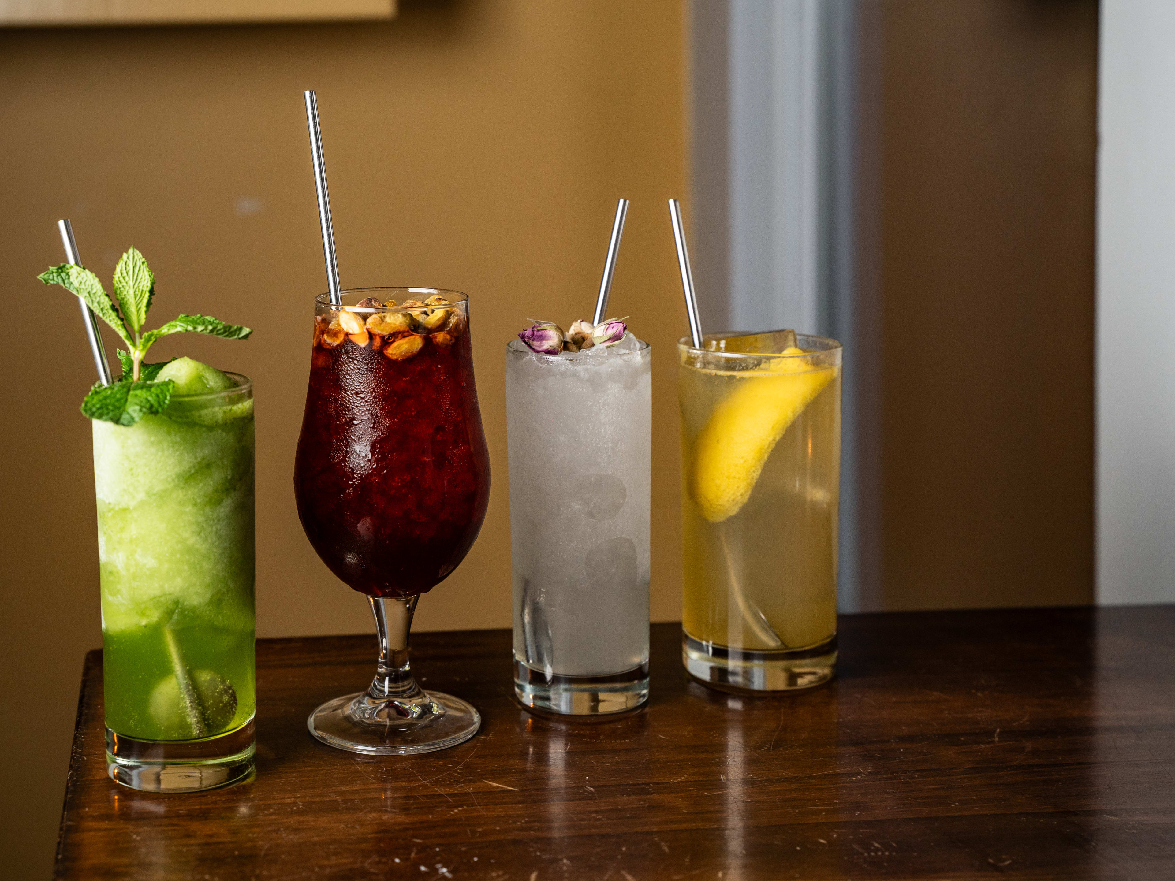 lineup of cocktails in different glasses