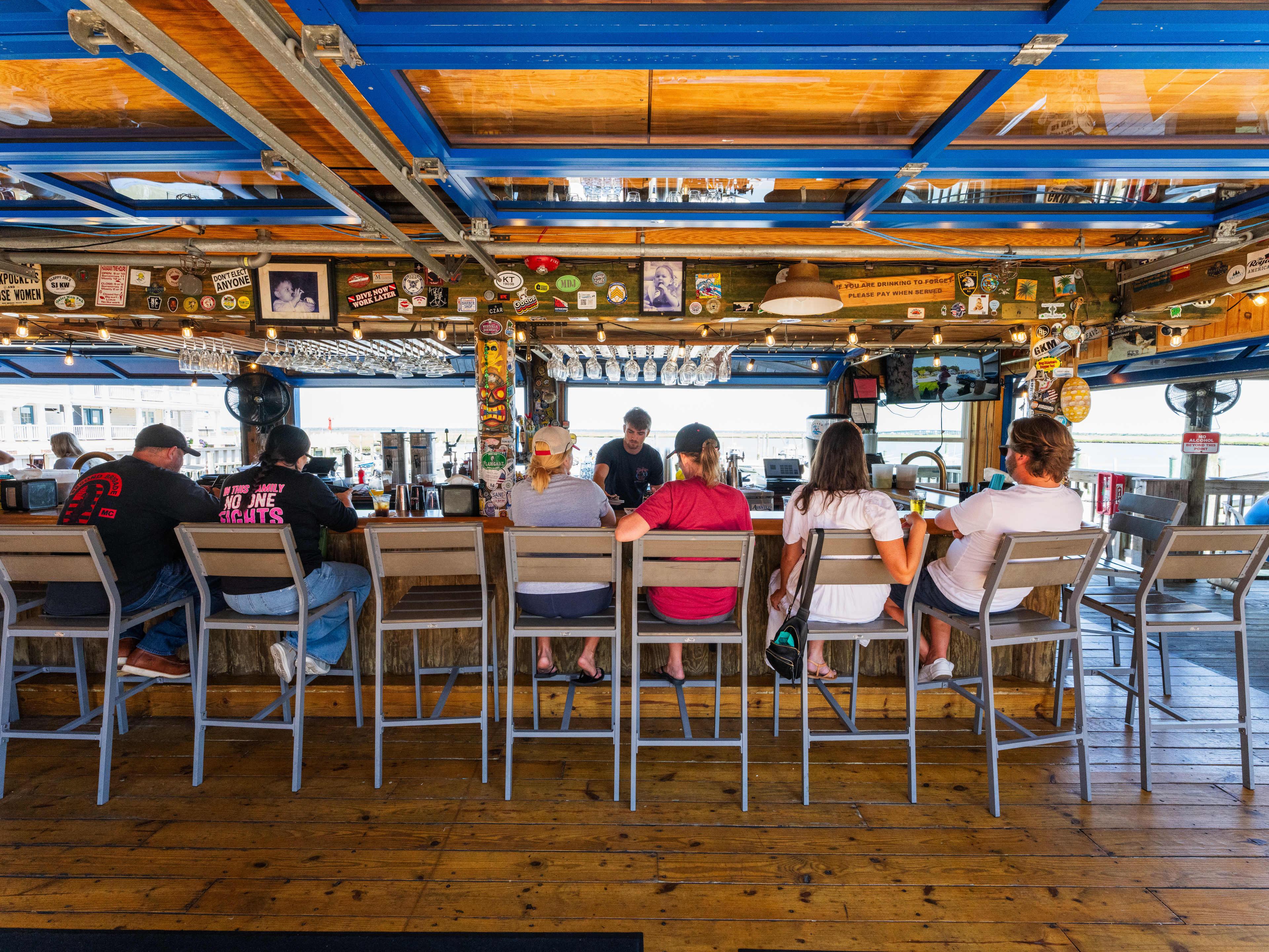 interior of beachfront restaurant with people sitting at bar