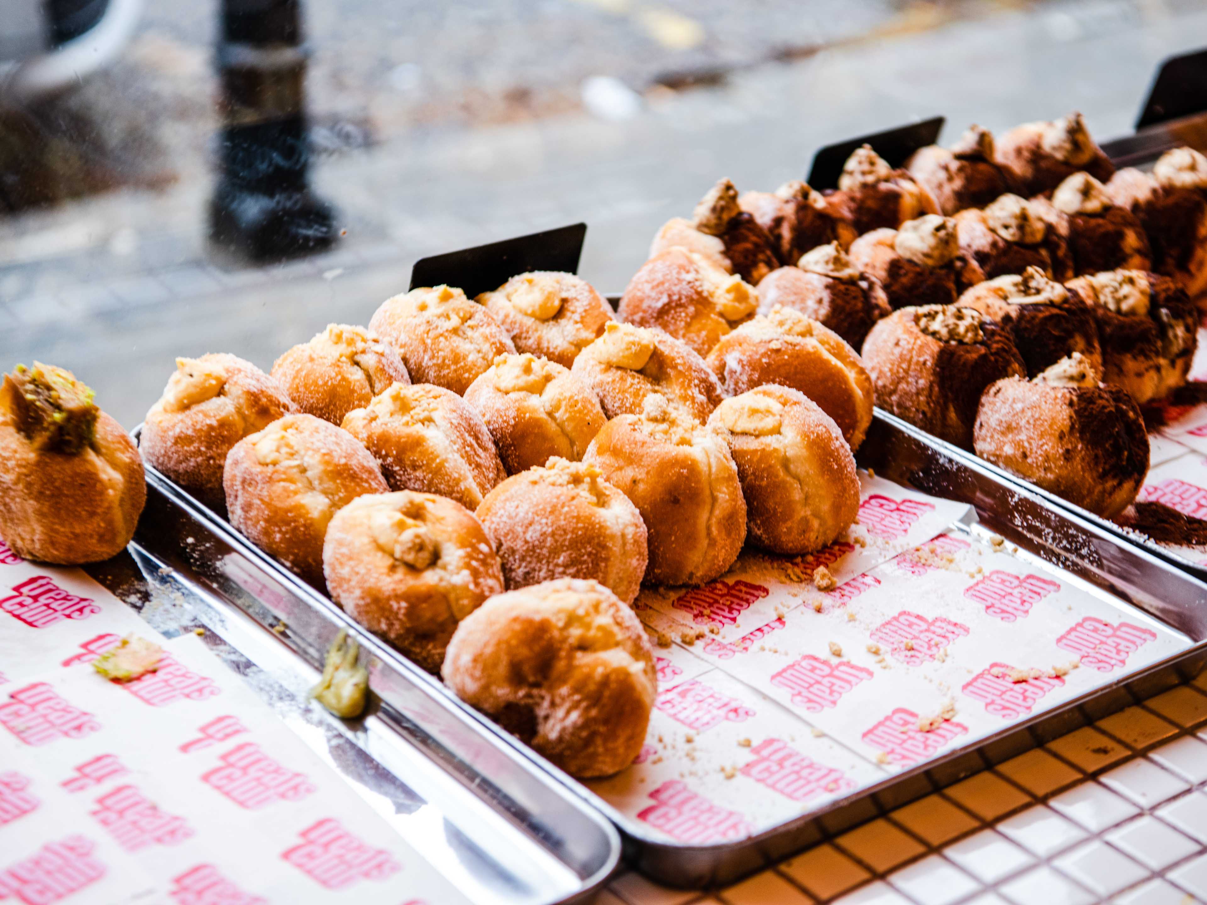 A spread of doughnuts in the window at The Treats Club.