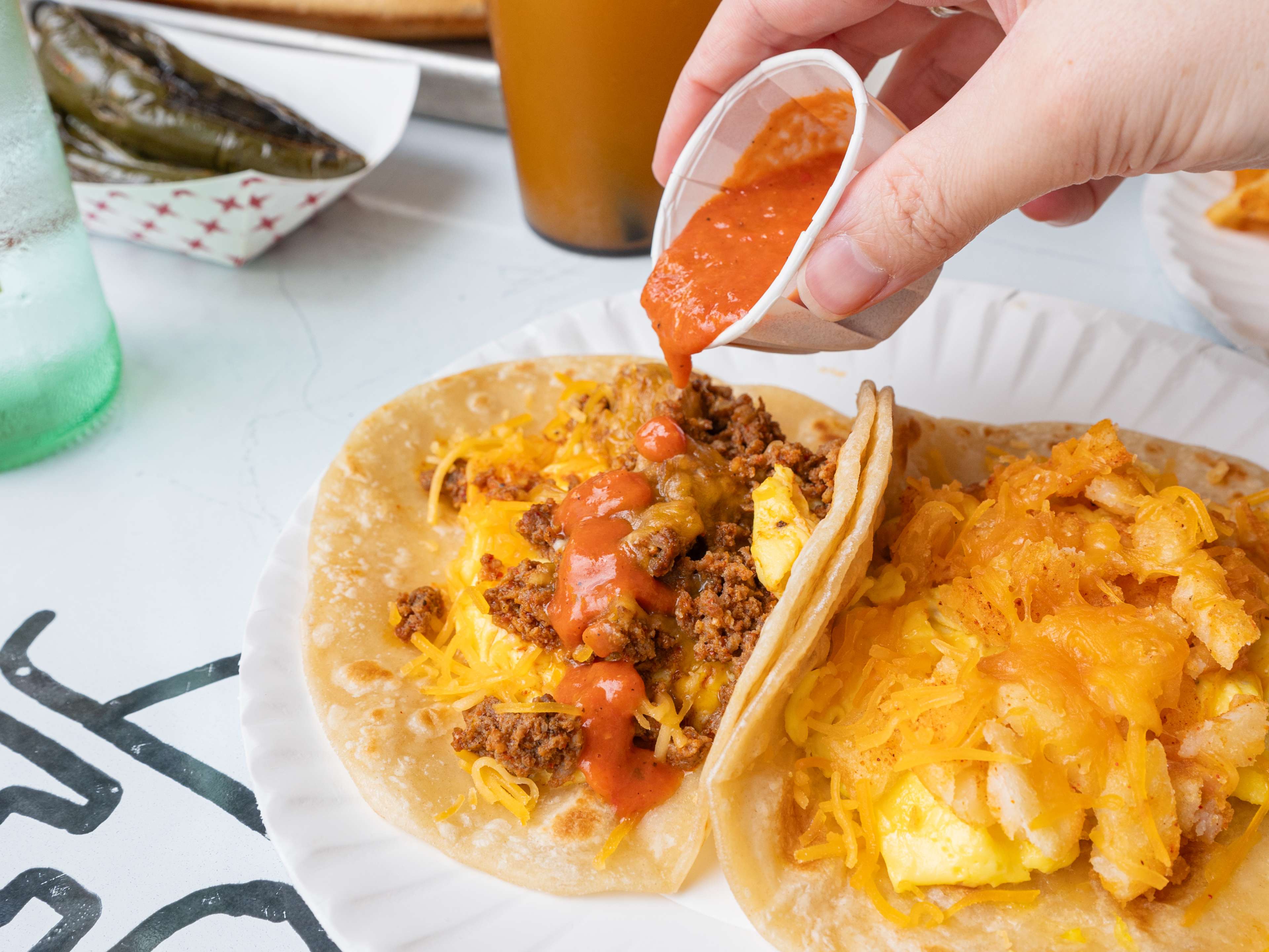 Breakfast tacos with hot sauce from Tio Fun.