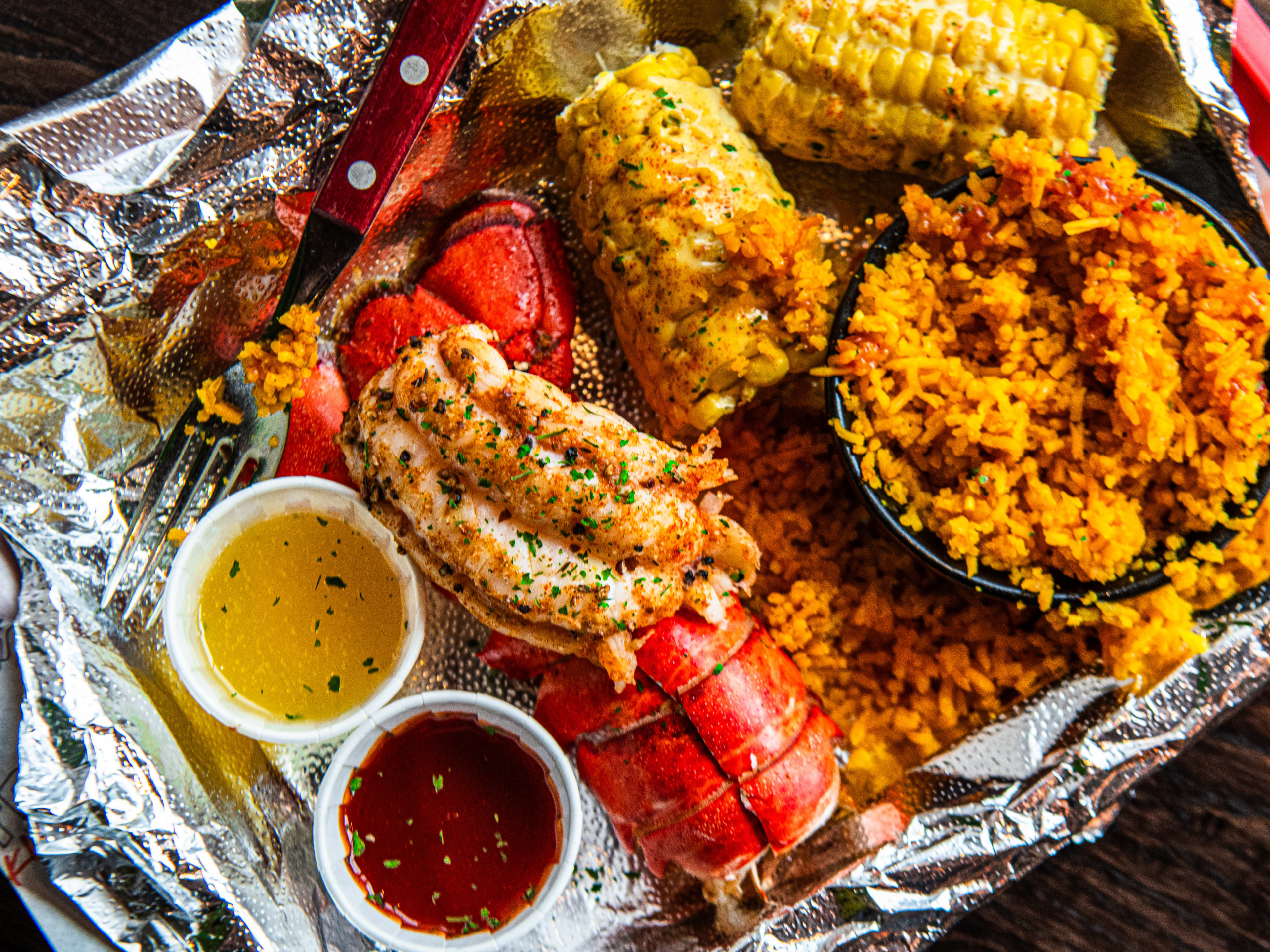 A slab with lobster tail and spanish rice from Trap Kitchen Camden.