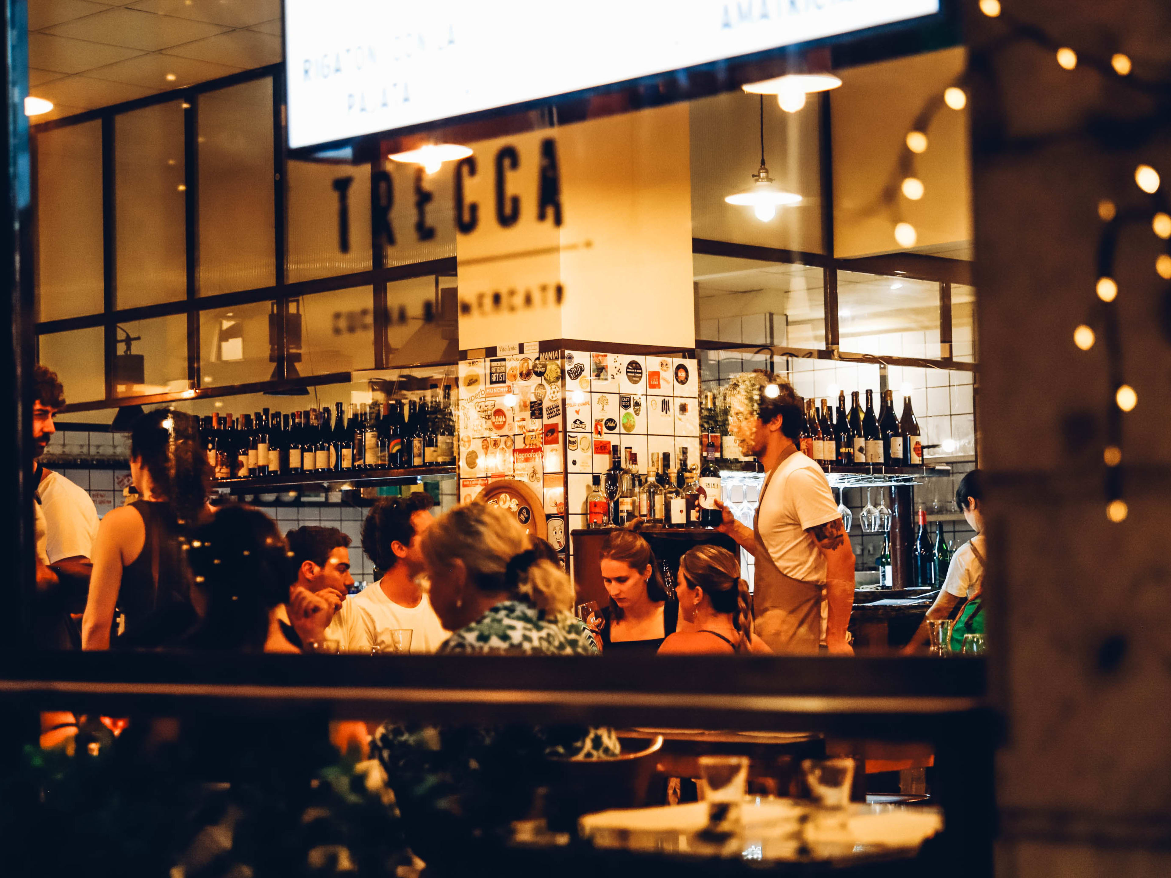 A peek into the window of Trattoria Trecca during busy dinner service