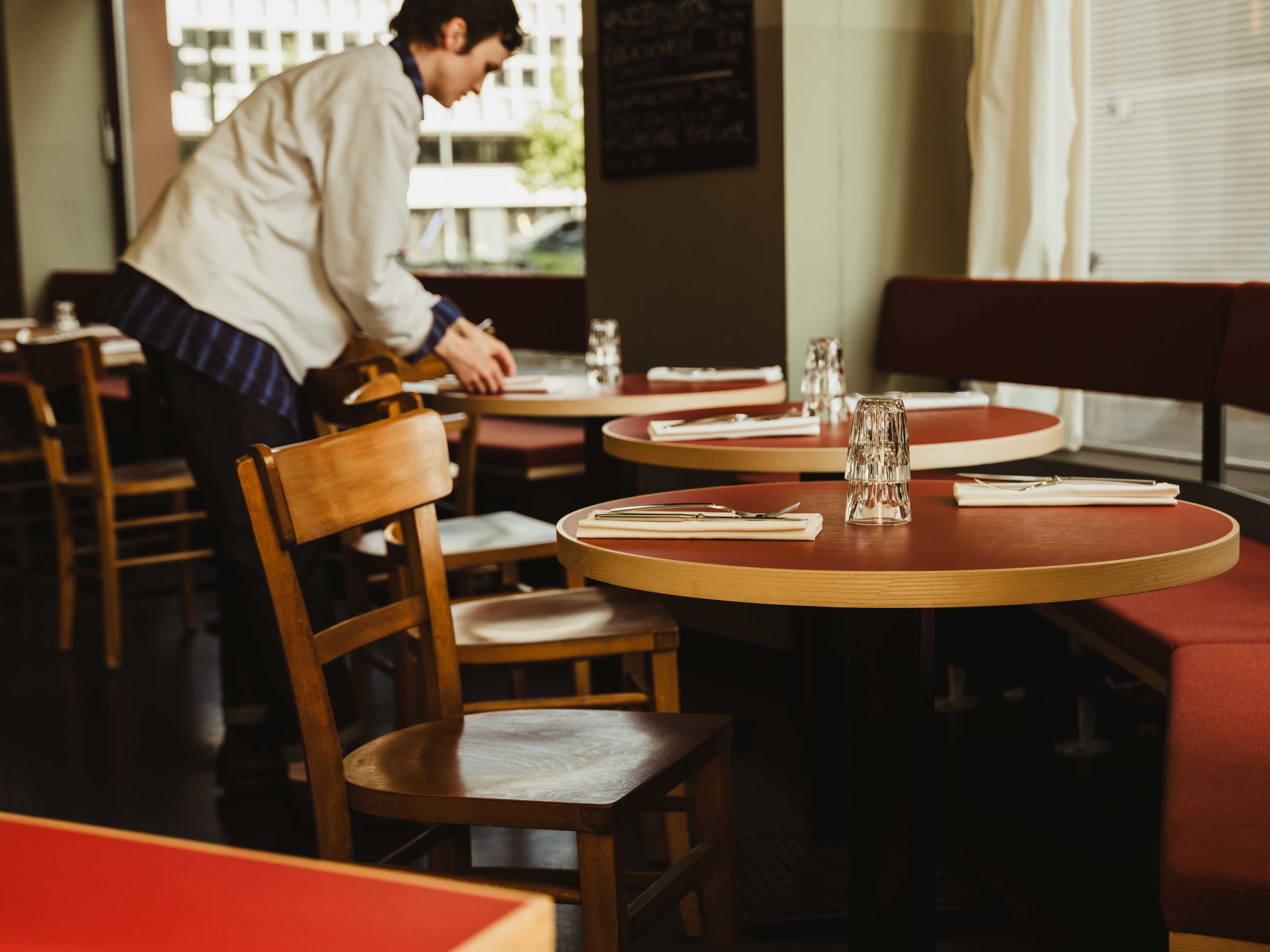 Set wooden and red tables at Trio