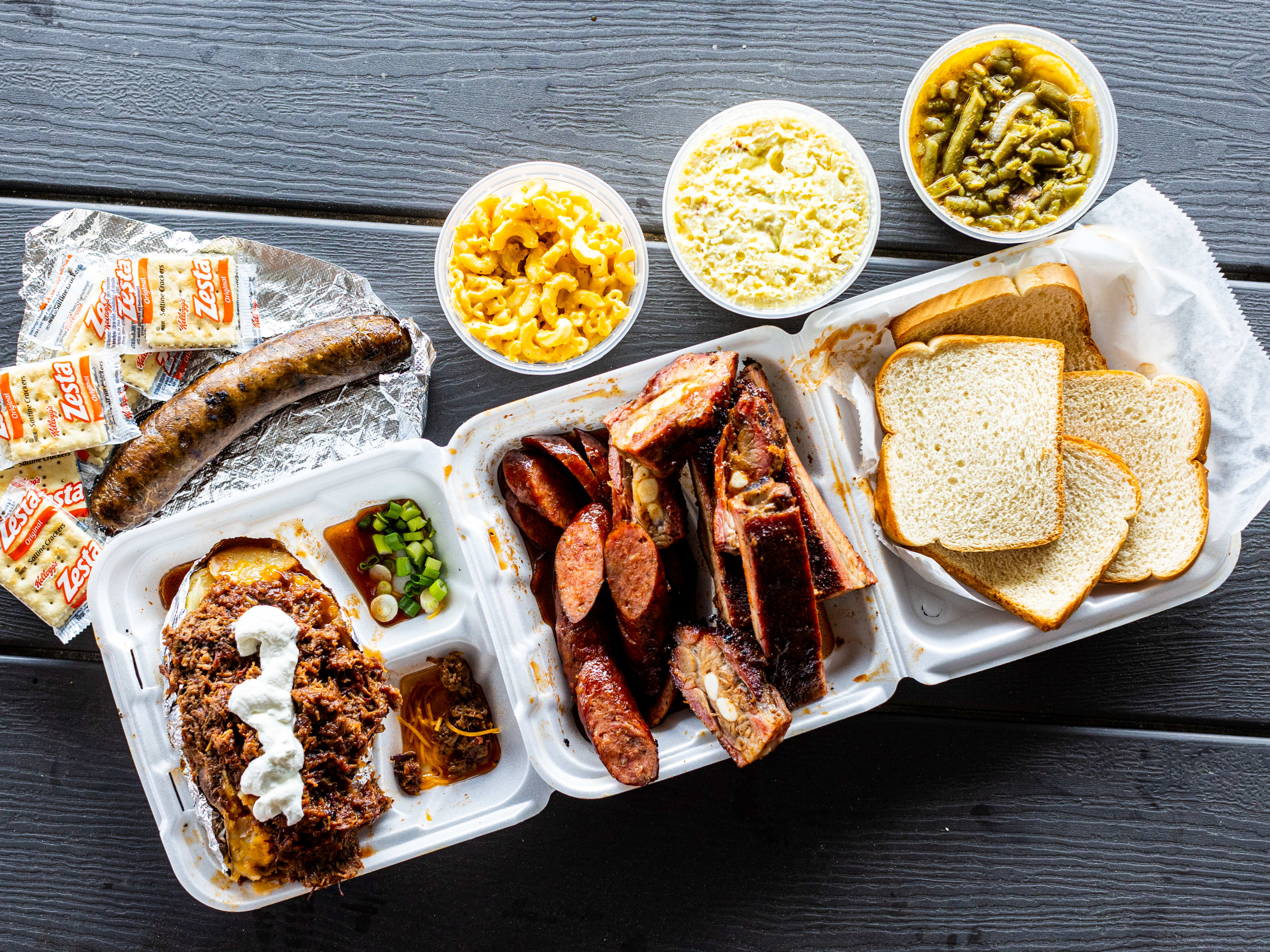 sausage, baked potato, and sides