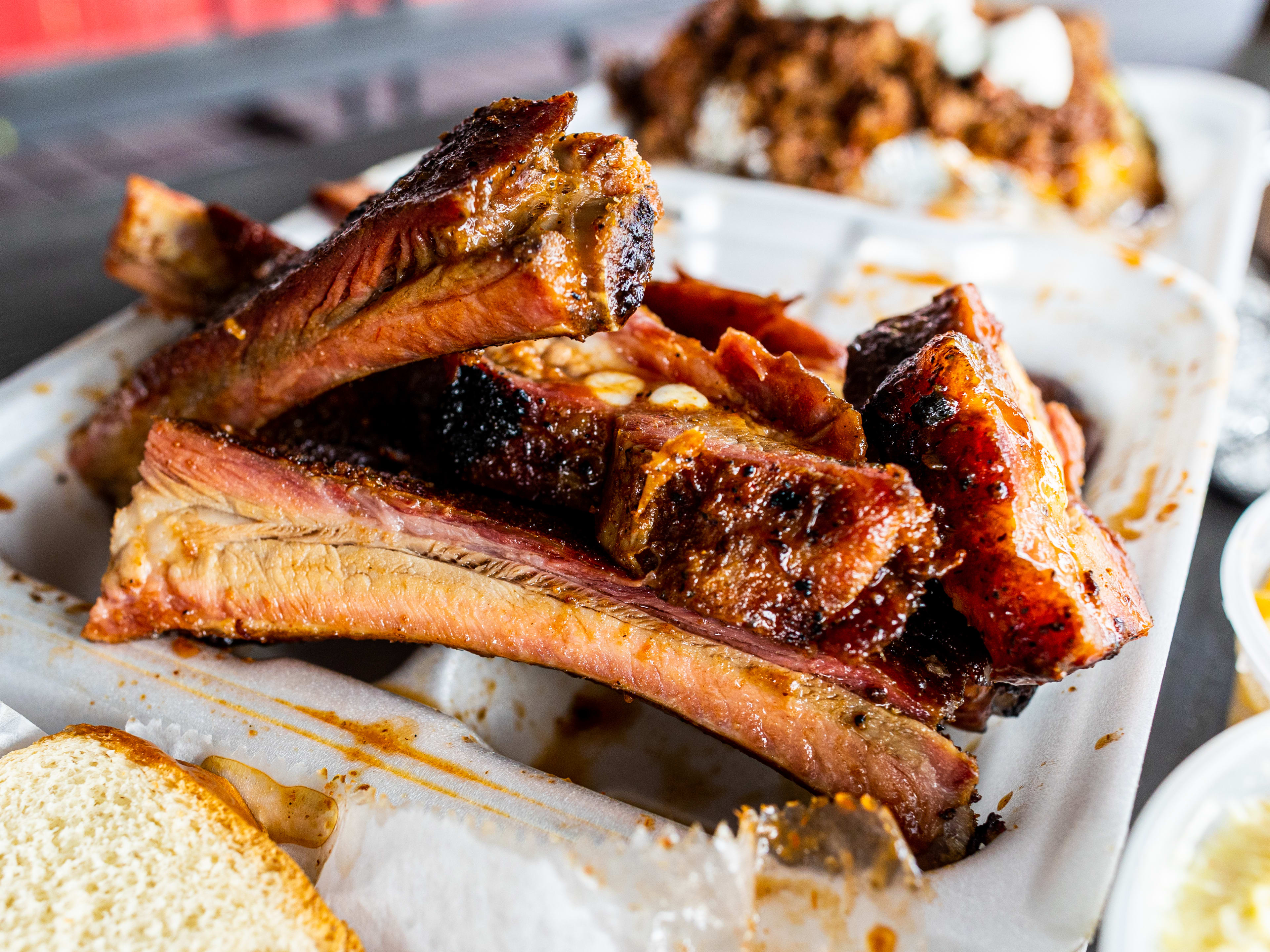 A styrofoam container filled with ribs