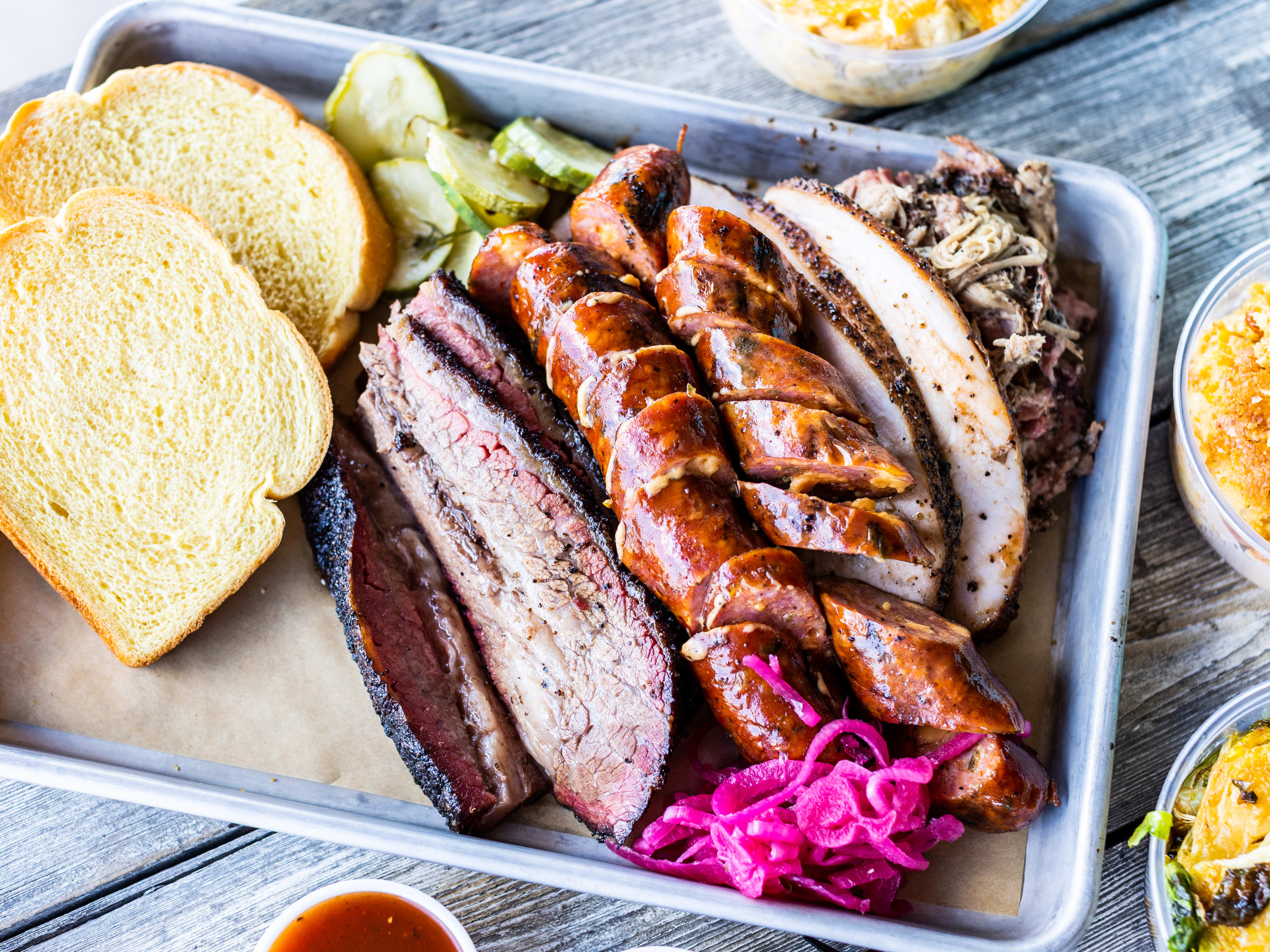 close of barbecue tray with turkey, sausage, and brisket