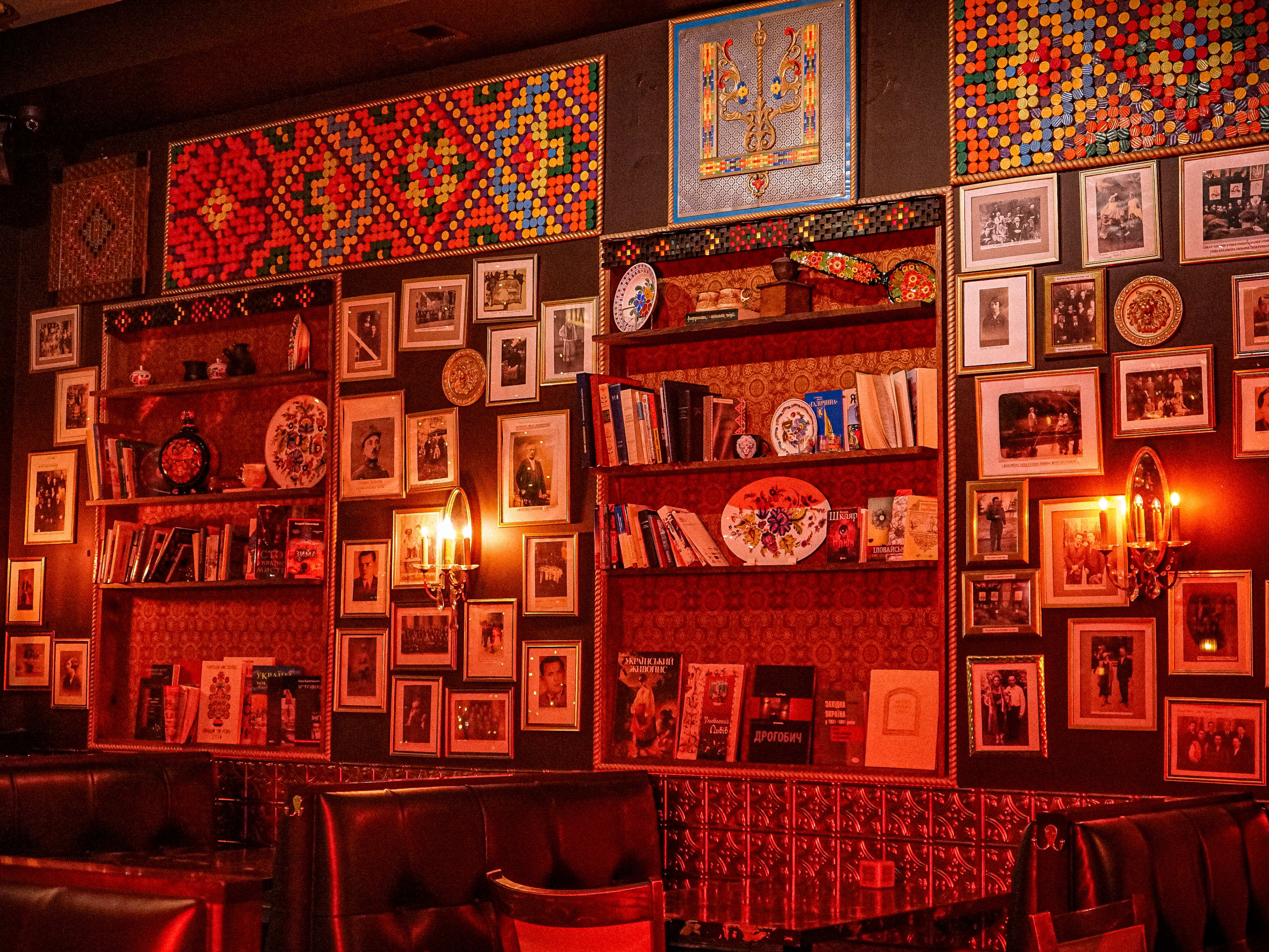 A wall full of books and framed pictures.