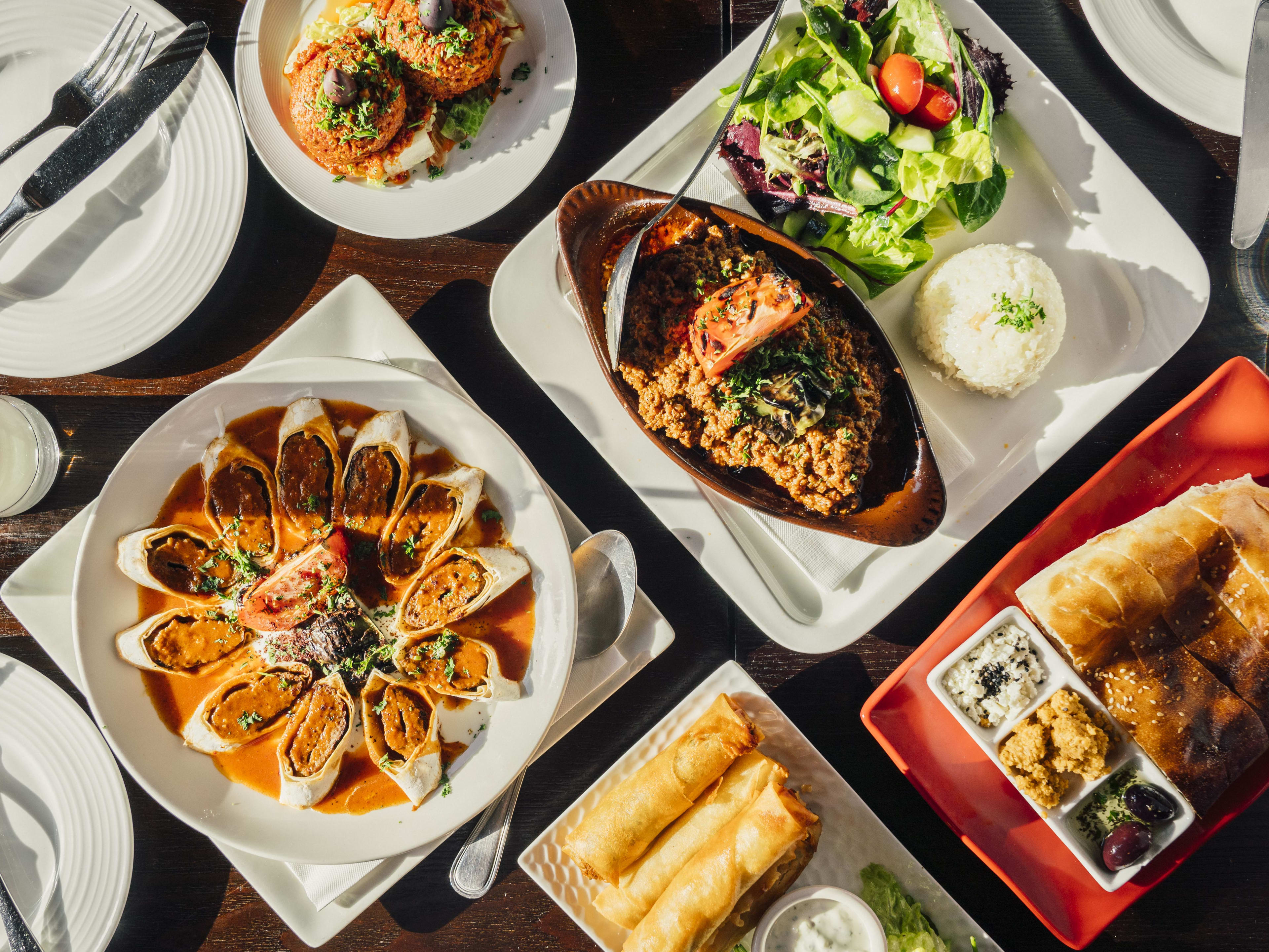 A spread of dishes and house bread at Tuba