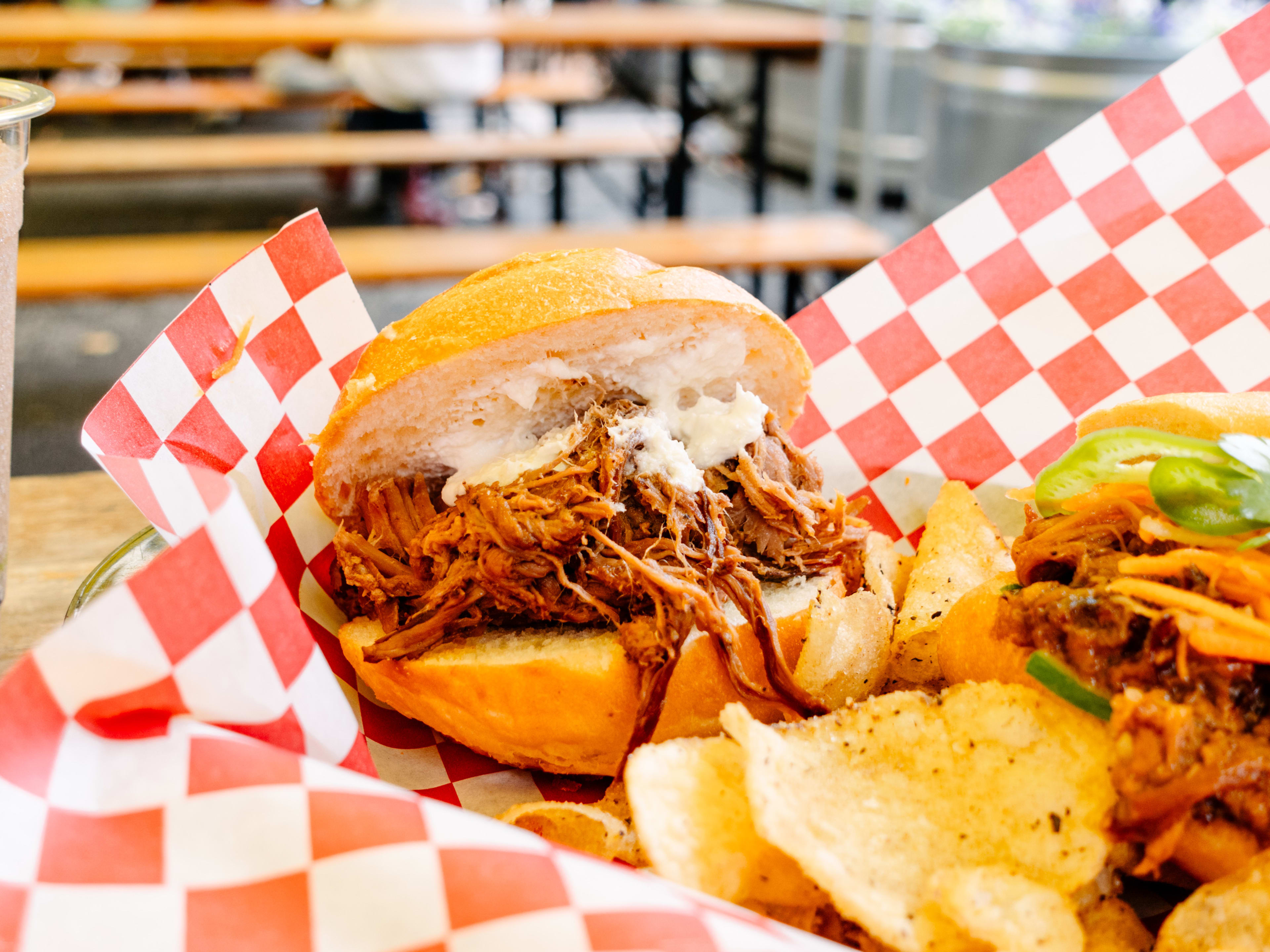 Braised beef and a dollop of horseradish sauce on a hamburger bun.