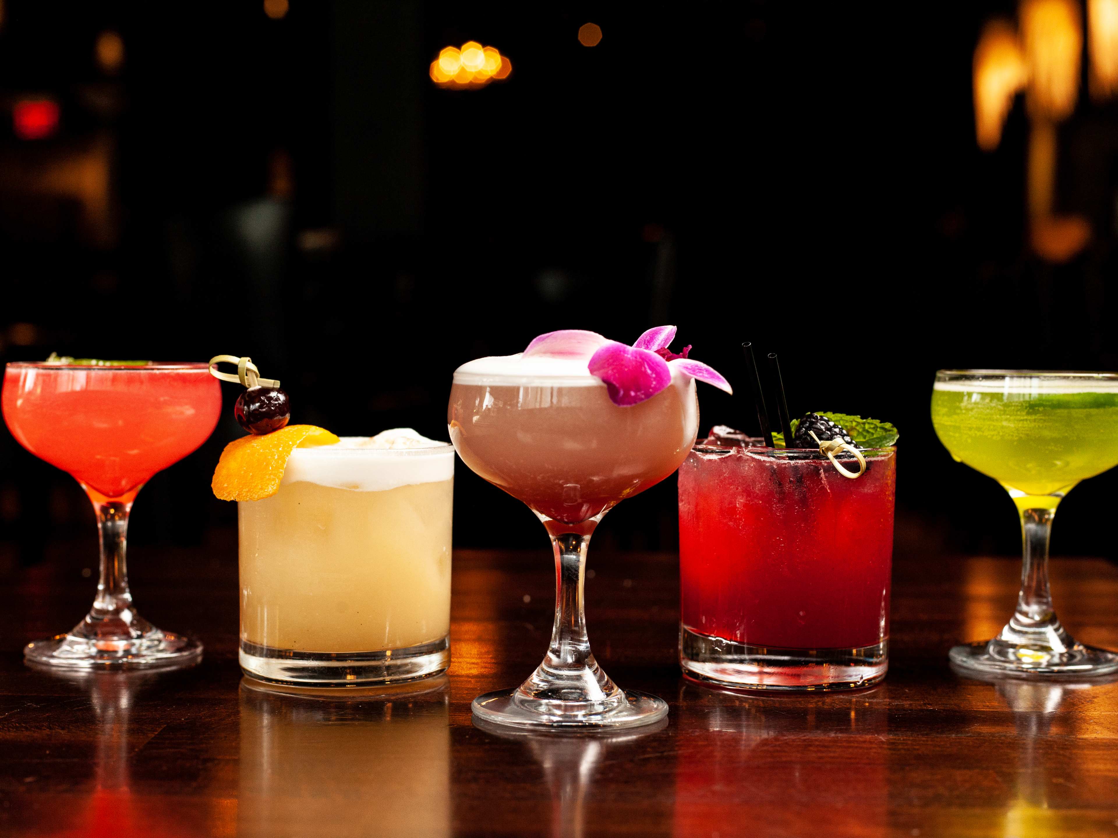 A line of five cocktails.