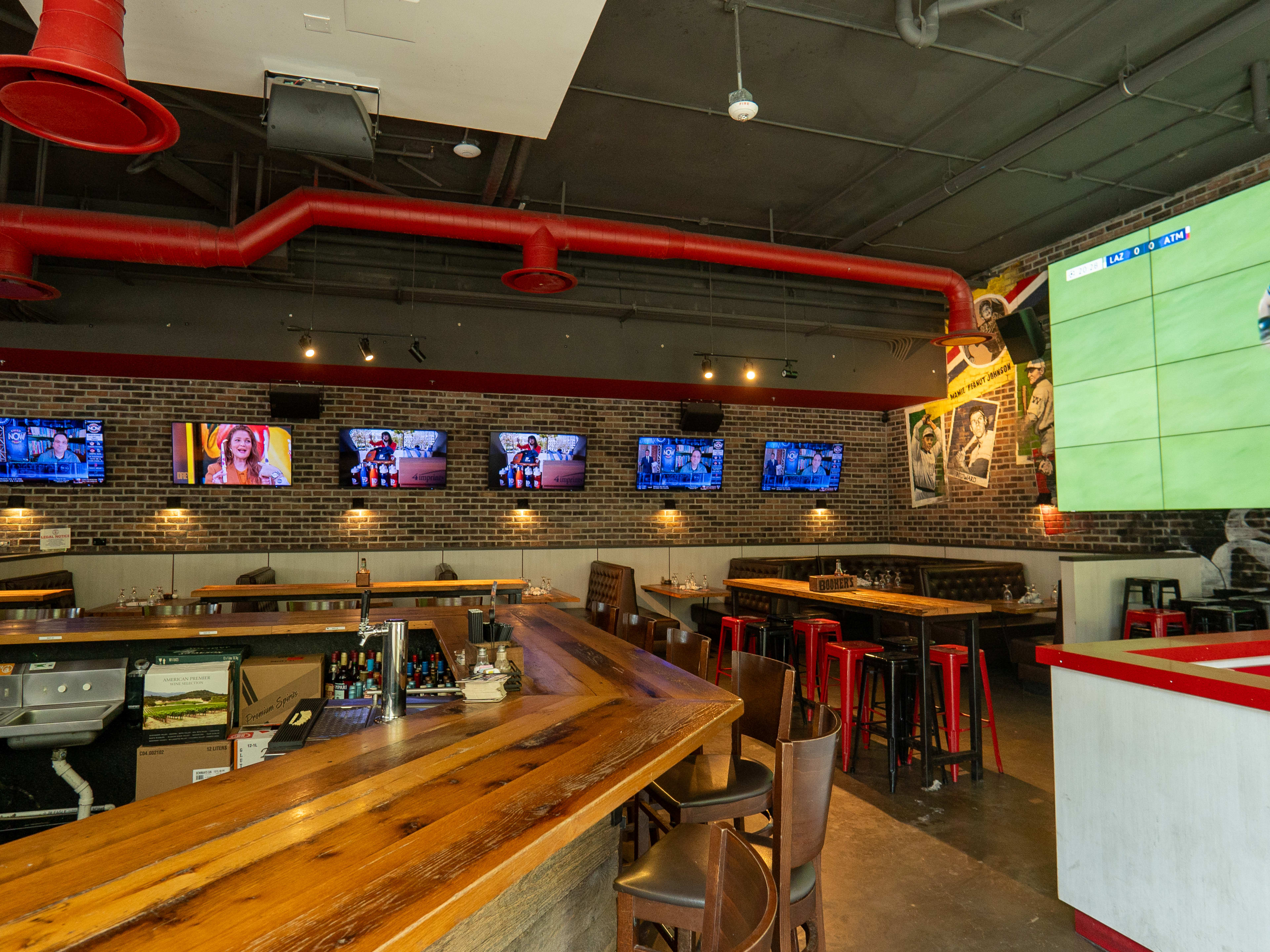 bar interior with multiple tv screens playing sports games