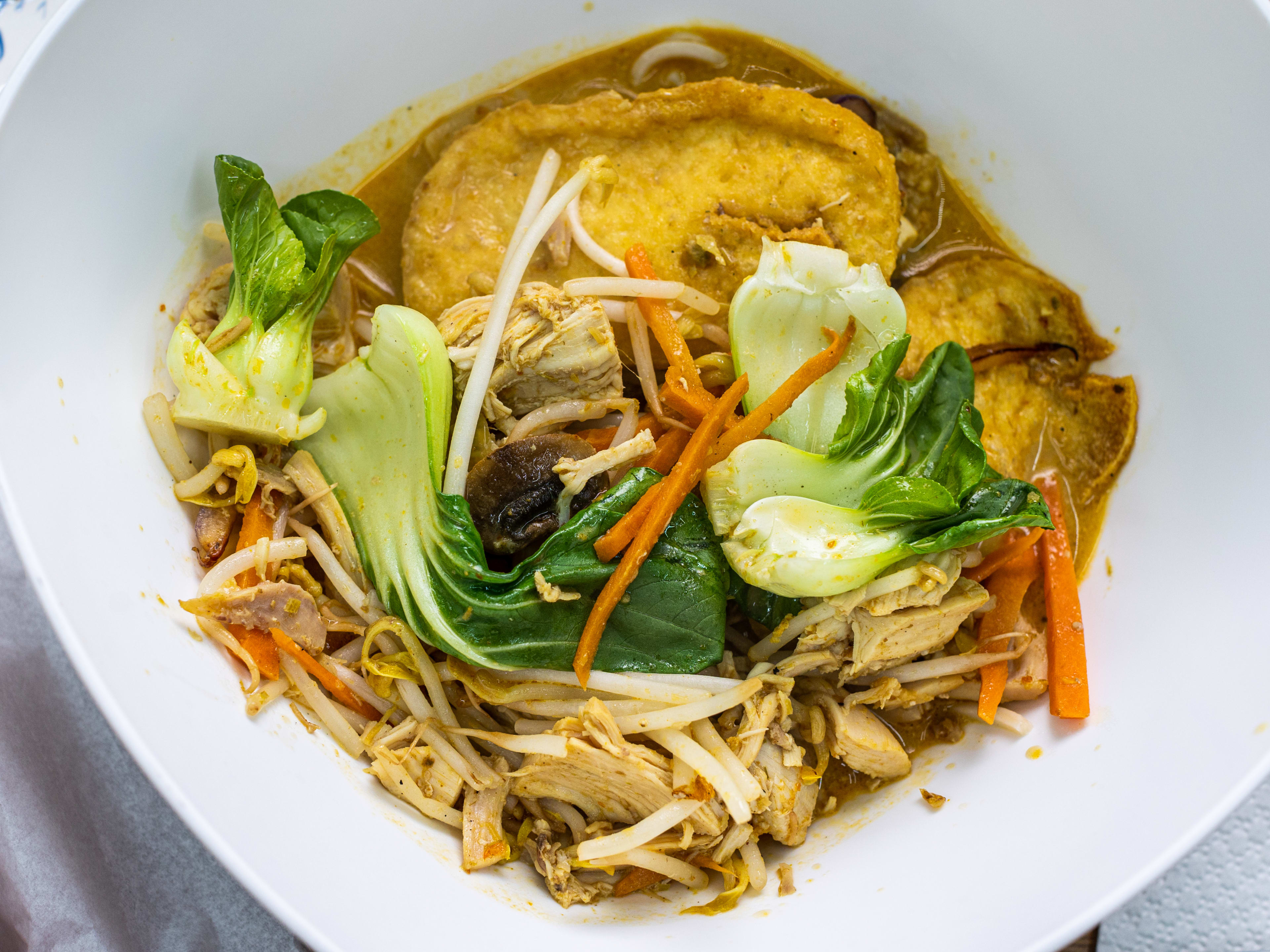 A white bowl of chicken curry laksa from Wee’s Cozy Kitchen.