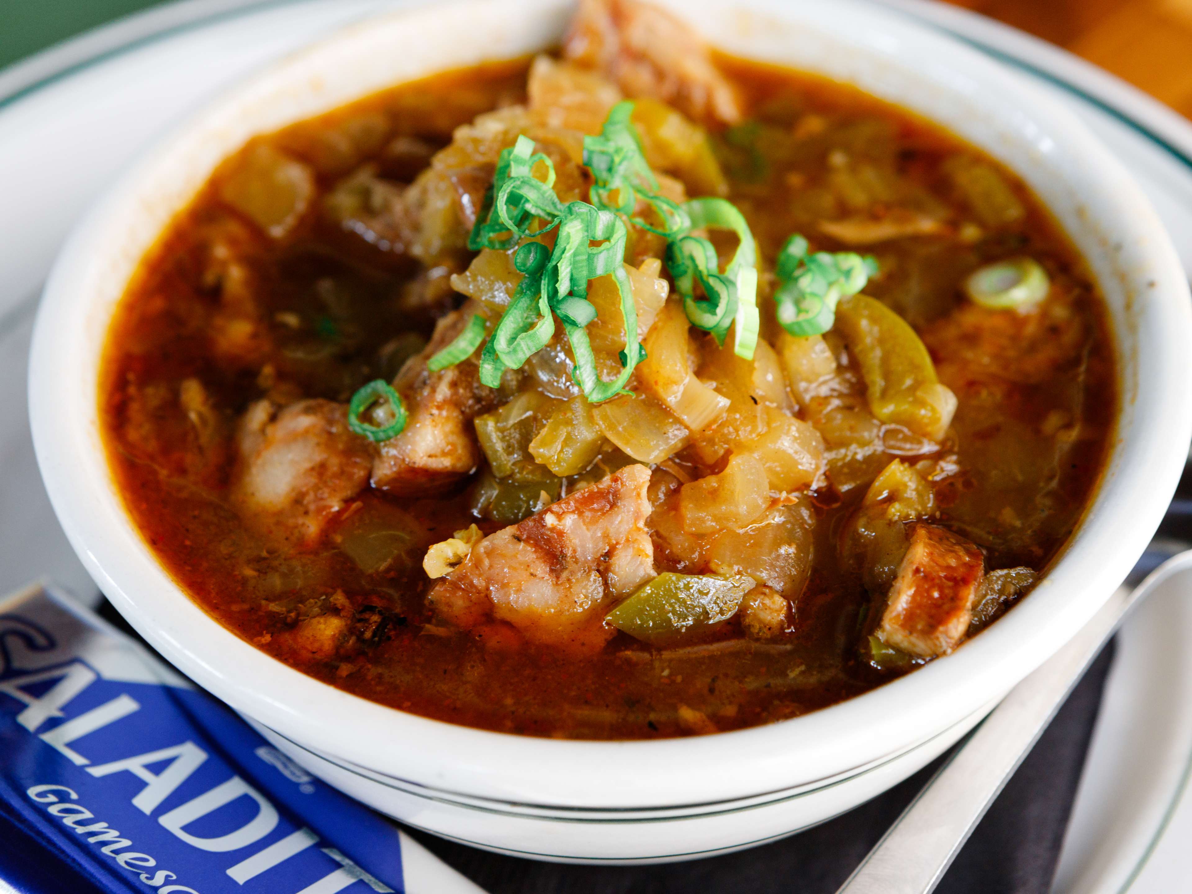 A bowl of gumbo with a side of crackers at Winnie's.