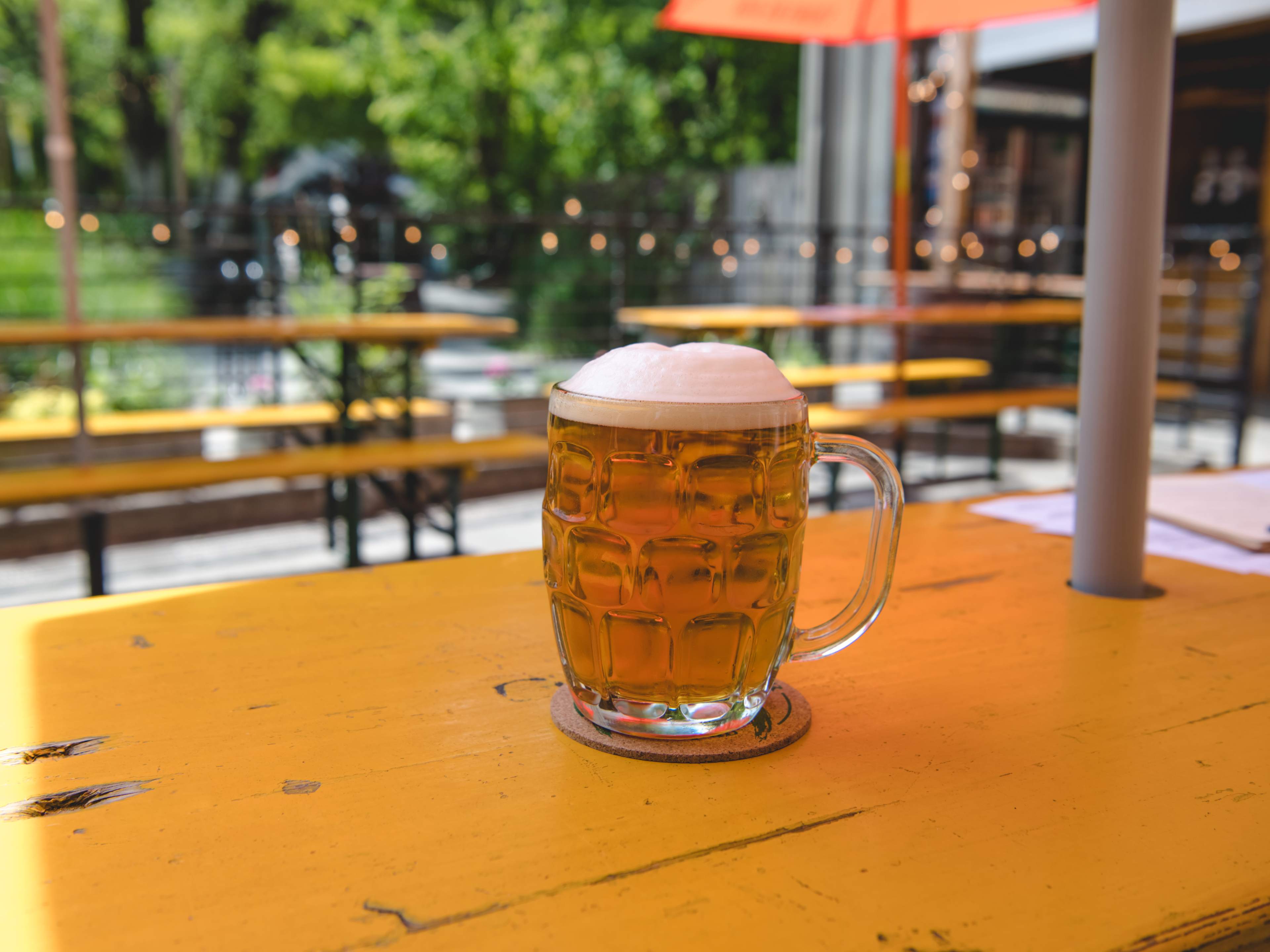 A mug of beer with foam on top.