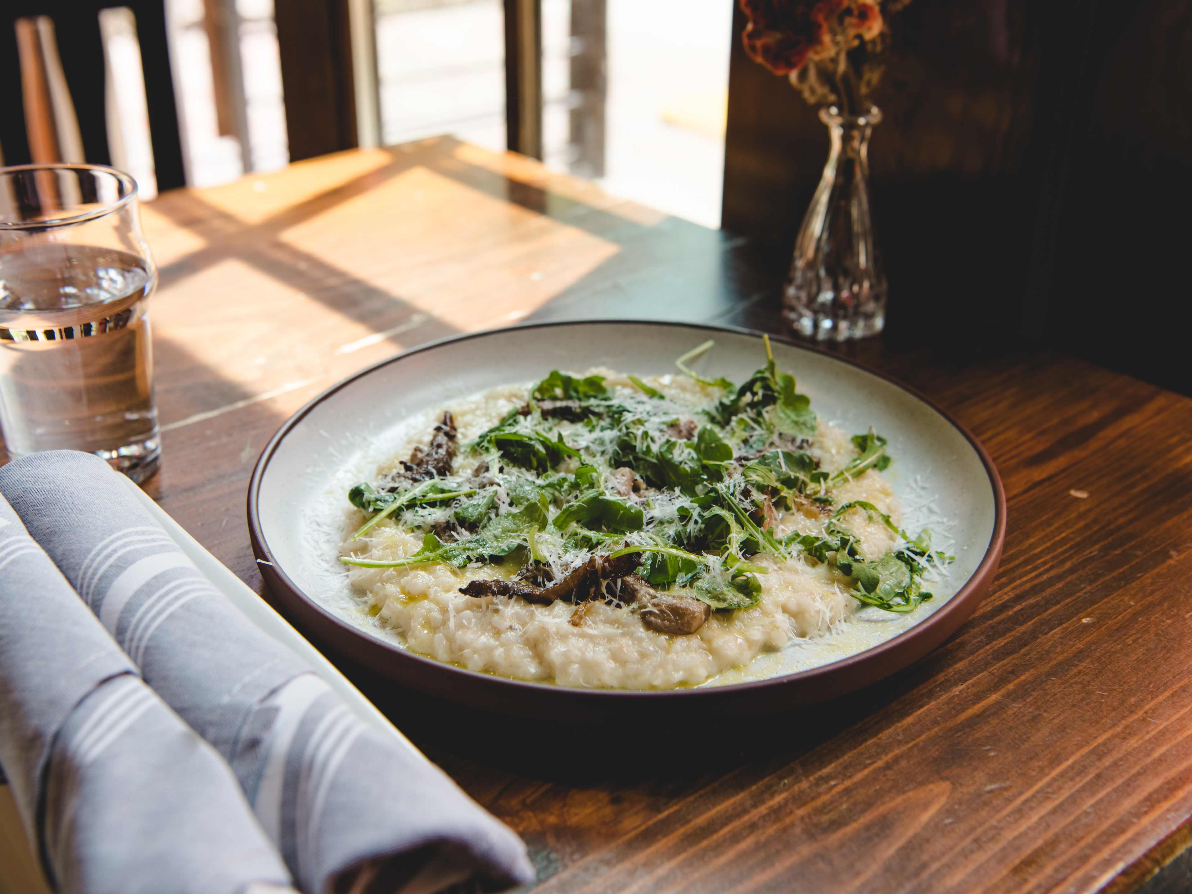 Risotto sitting on a wooden table.