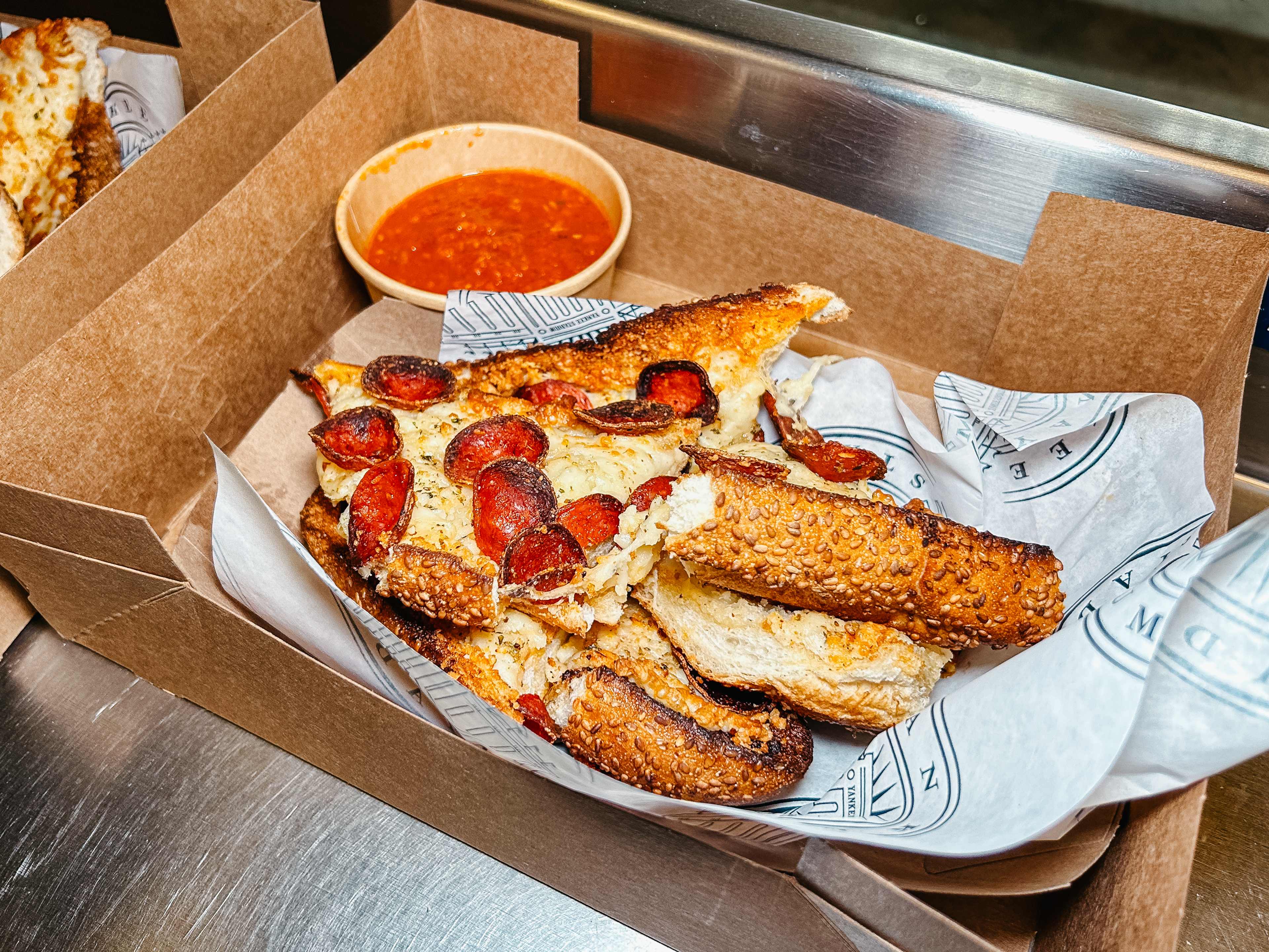 cheesy garlic bread with pepperoni cups and a cup of tomato sauce