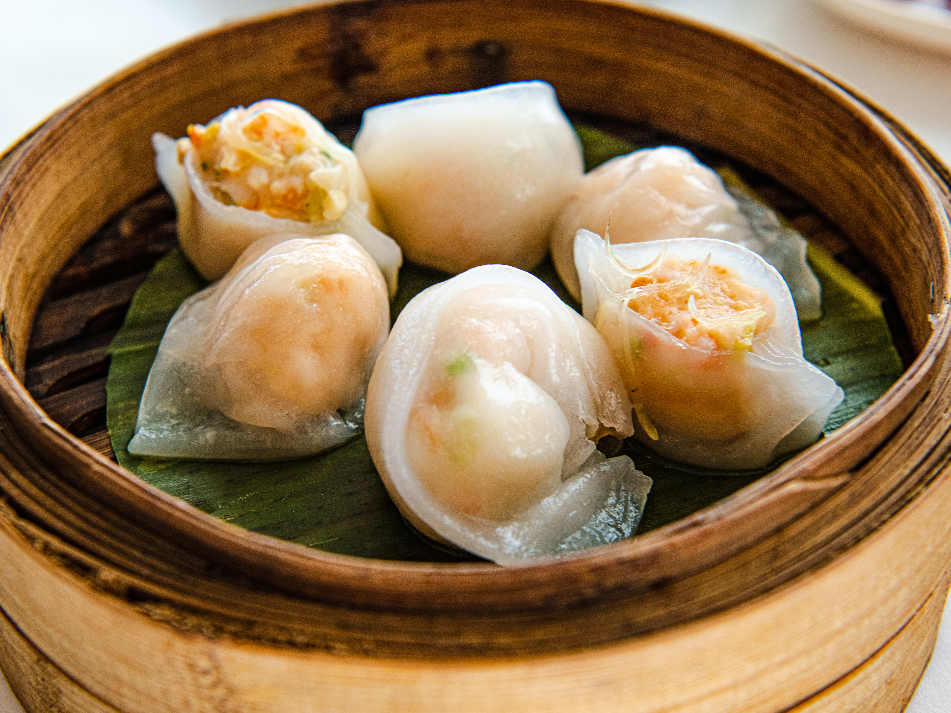 A dim sum steamer basket with dumplings.